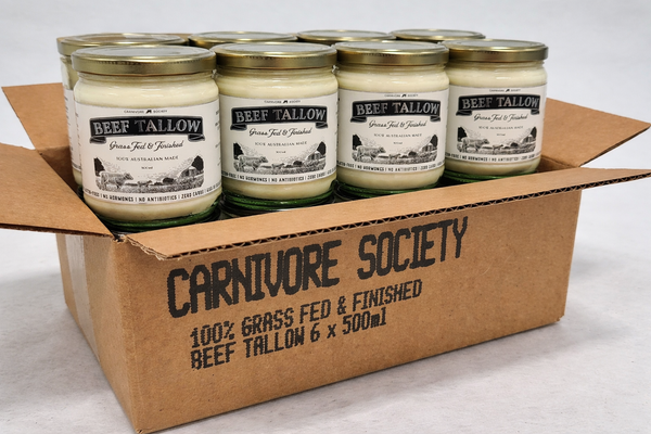 Box of grass-fed beef tallow jars branded Carnivore Society arranged in a cardboard carton for bulk purchase.