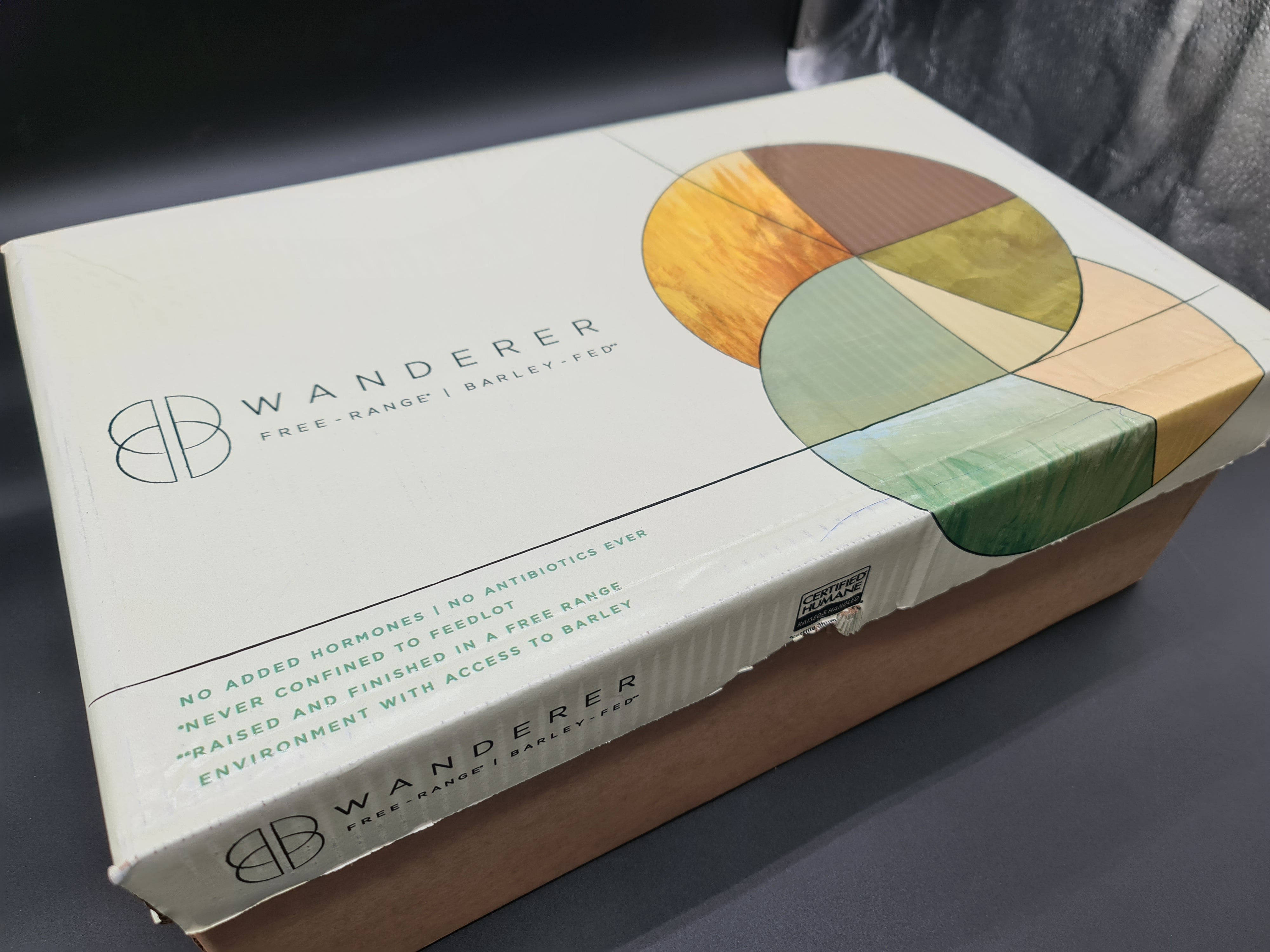 Closed Wanderer free-range barley-fed beef box on a dark surface