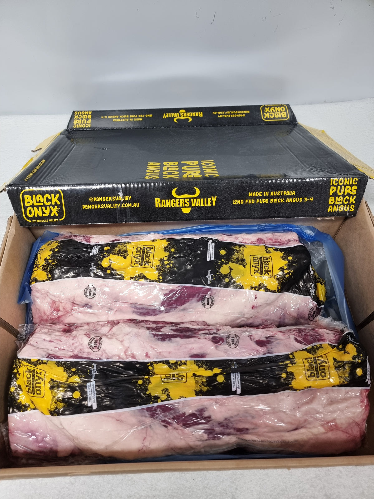Premium beef product label with packed cuts behind