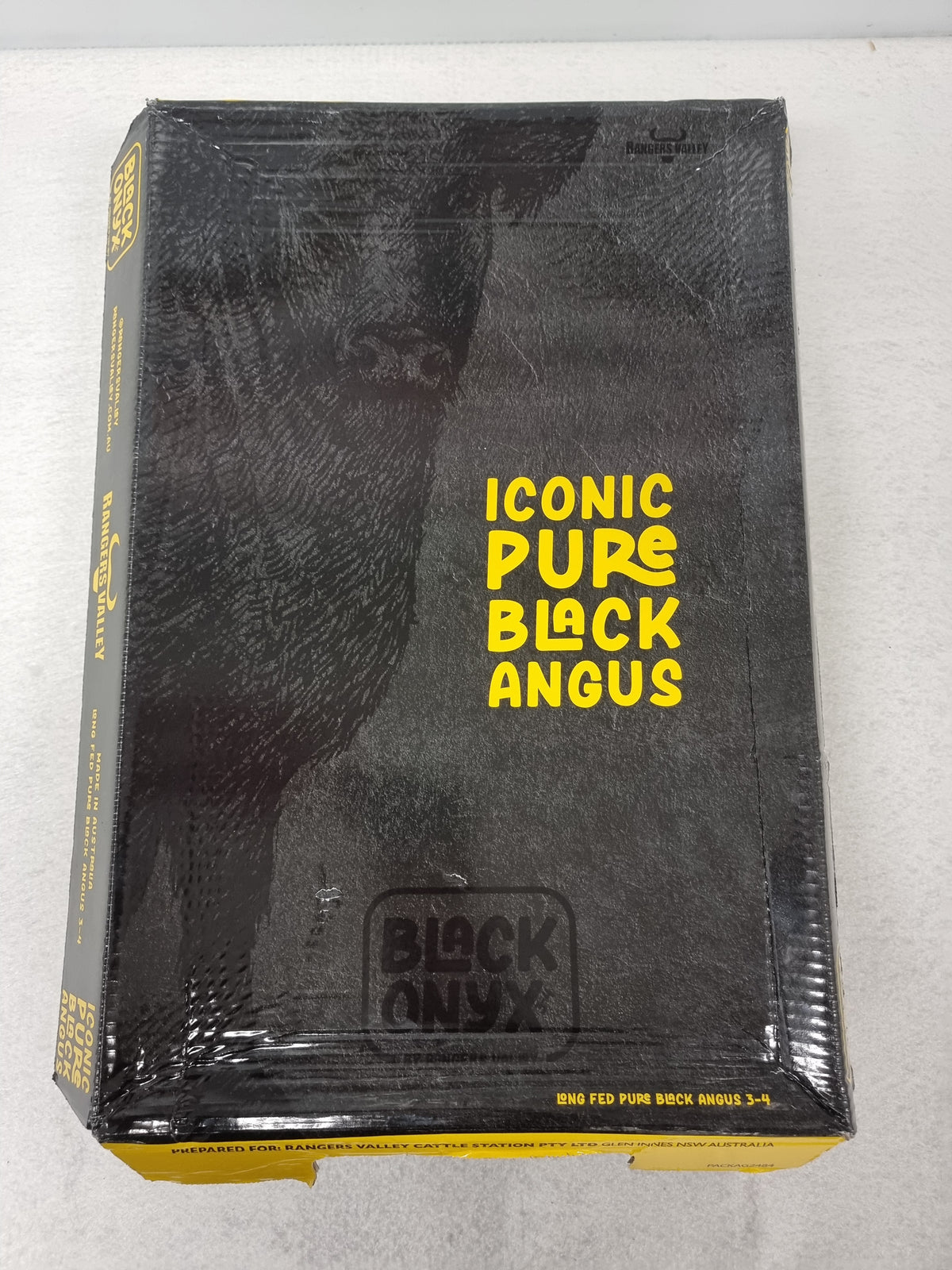 Premium beef carton label with packed cuts behind