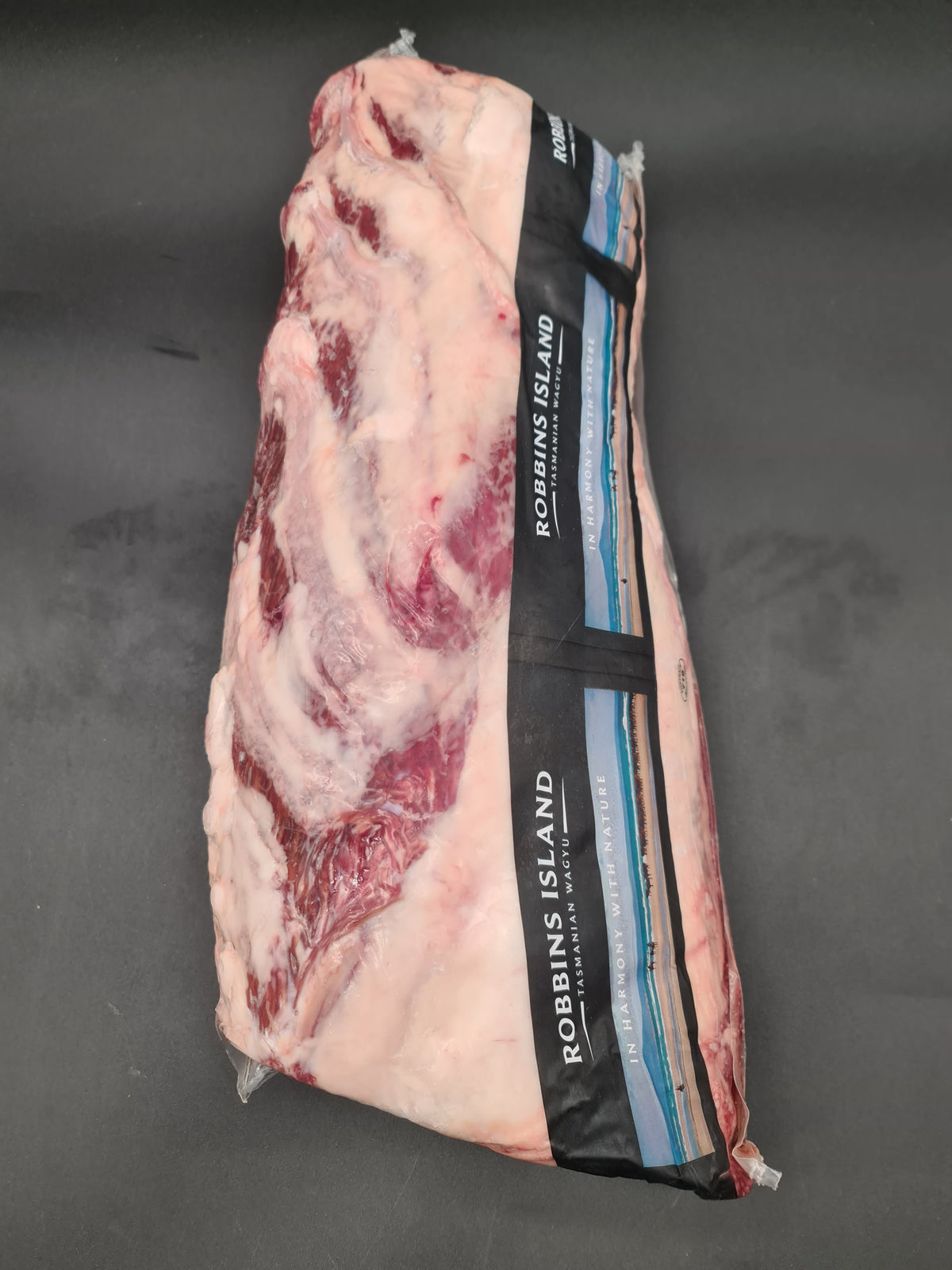 Close-up of two premium beef cuts with visible fat caps