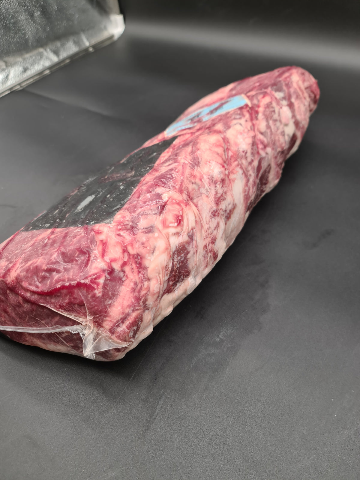 Two premium beef cuts side by side in vacuum packaging