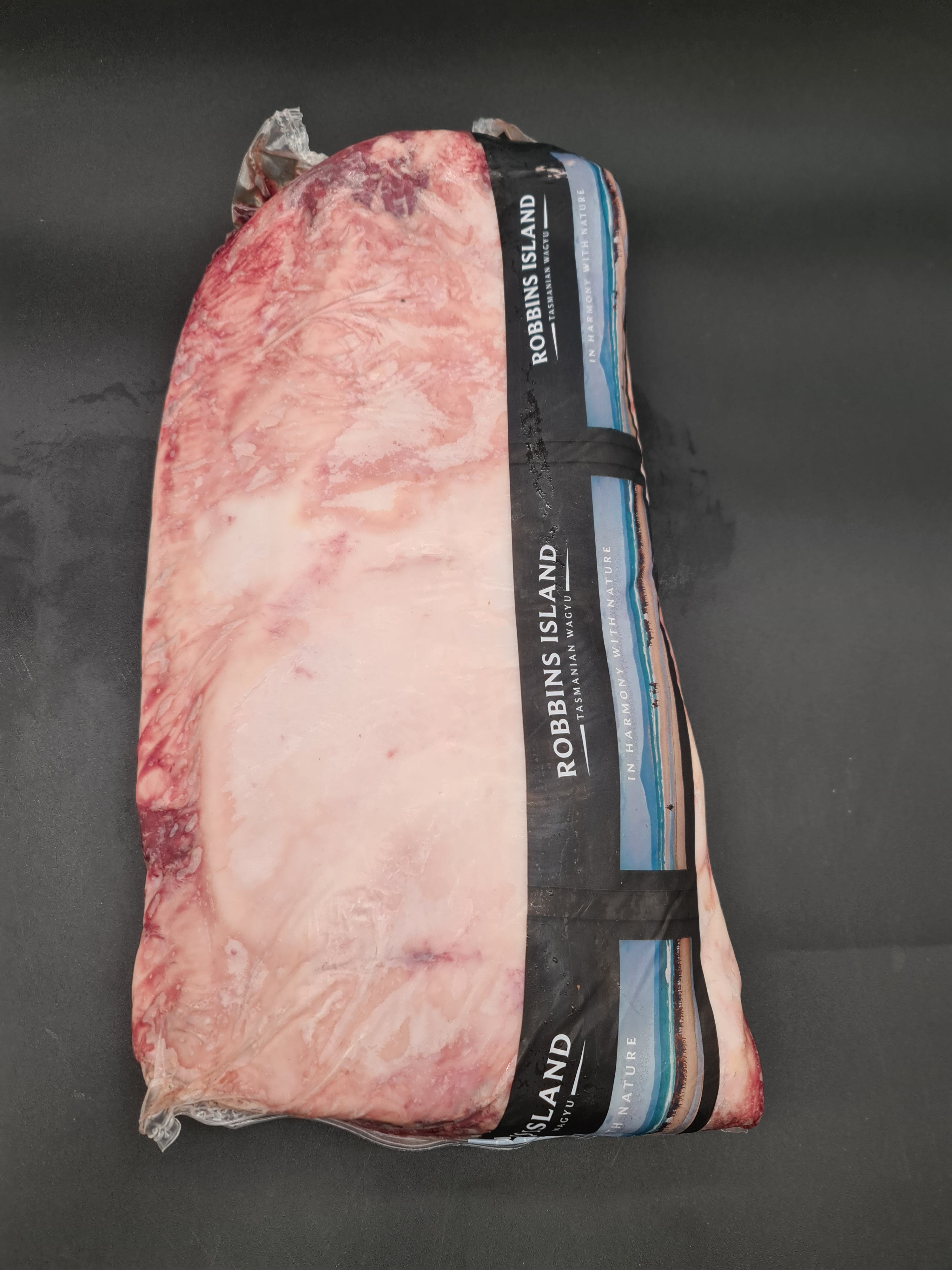 Vacuum-packed premium beef cut on a dark surface