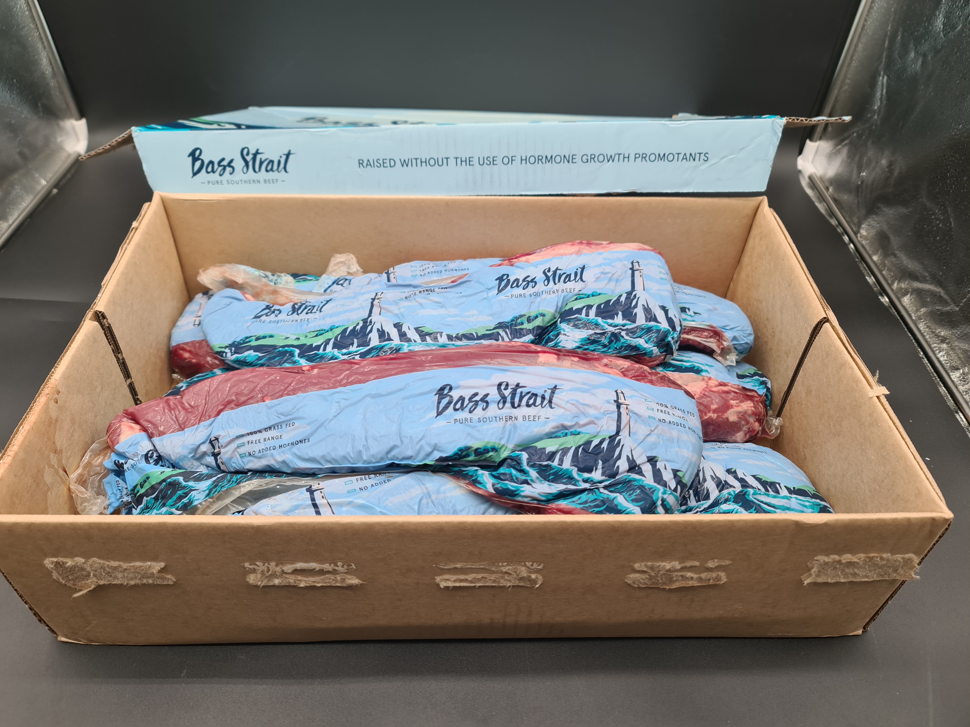 Open premium beef box with vacuum-packed cuts inside