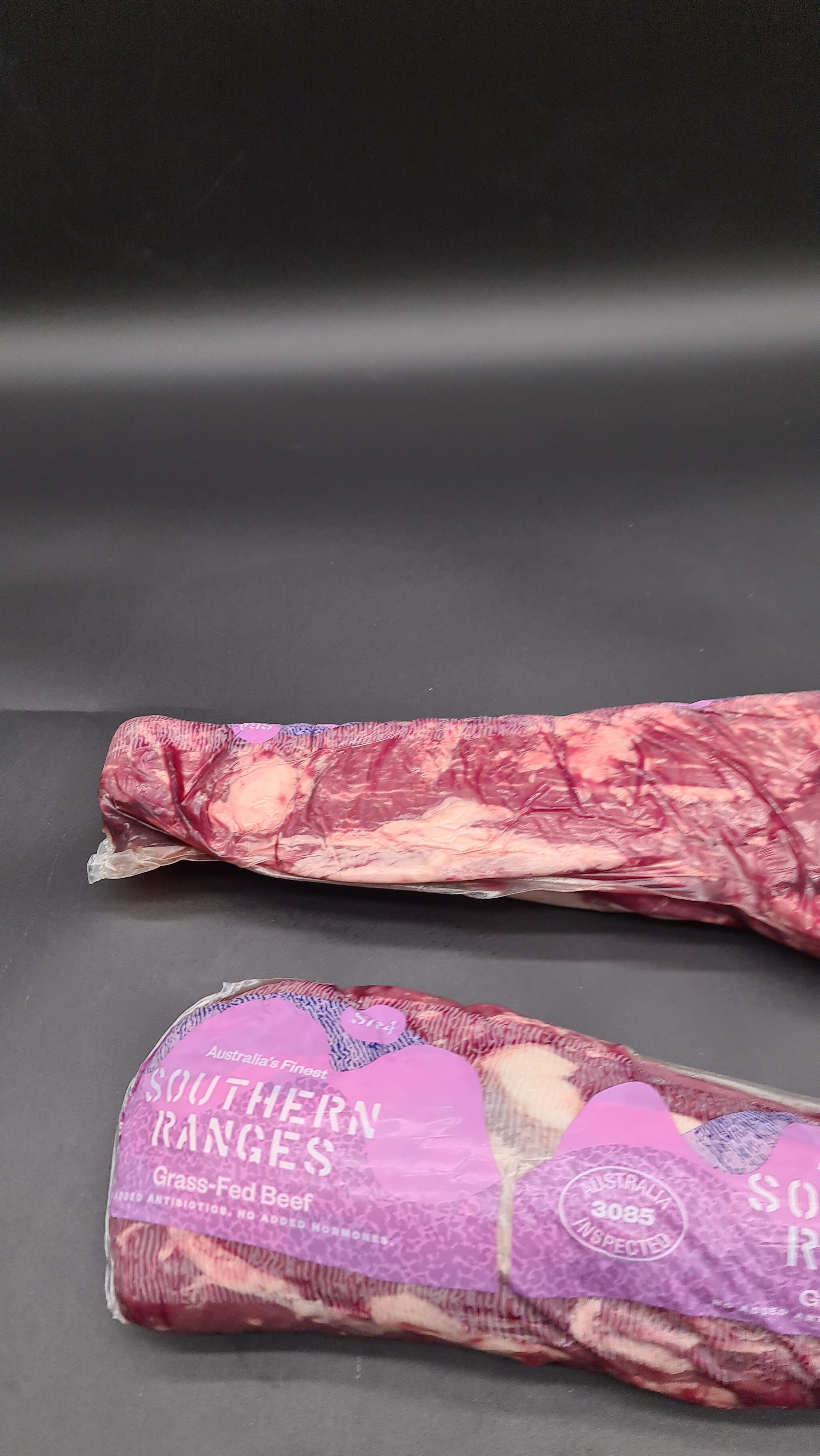 Butcher preparing a raw beef steak on a cutting board