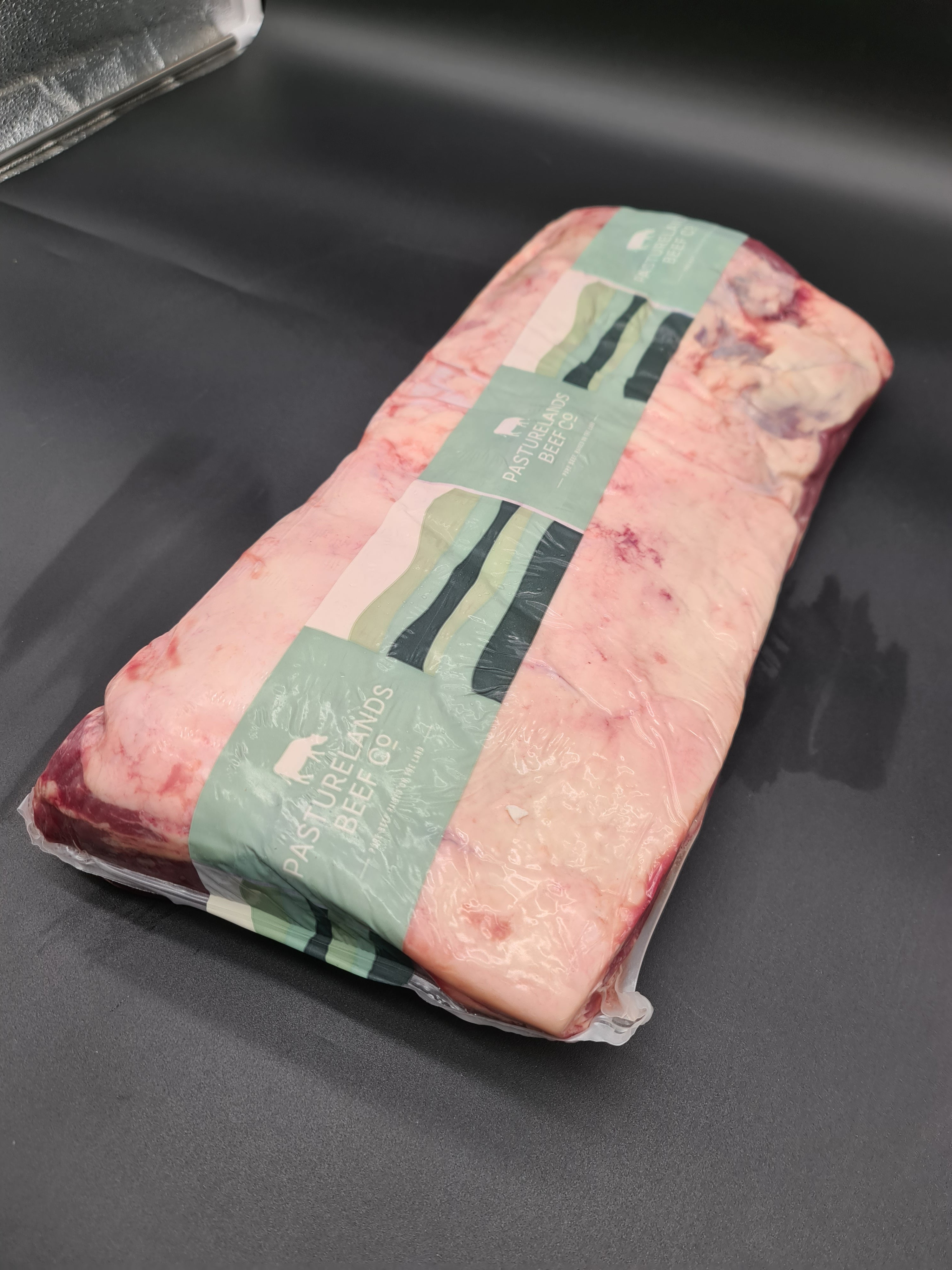 Vacuum-packed premium beef cut on a dark surface