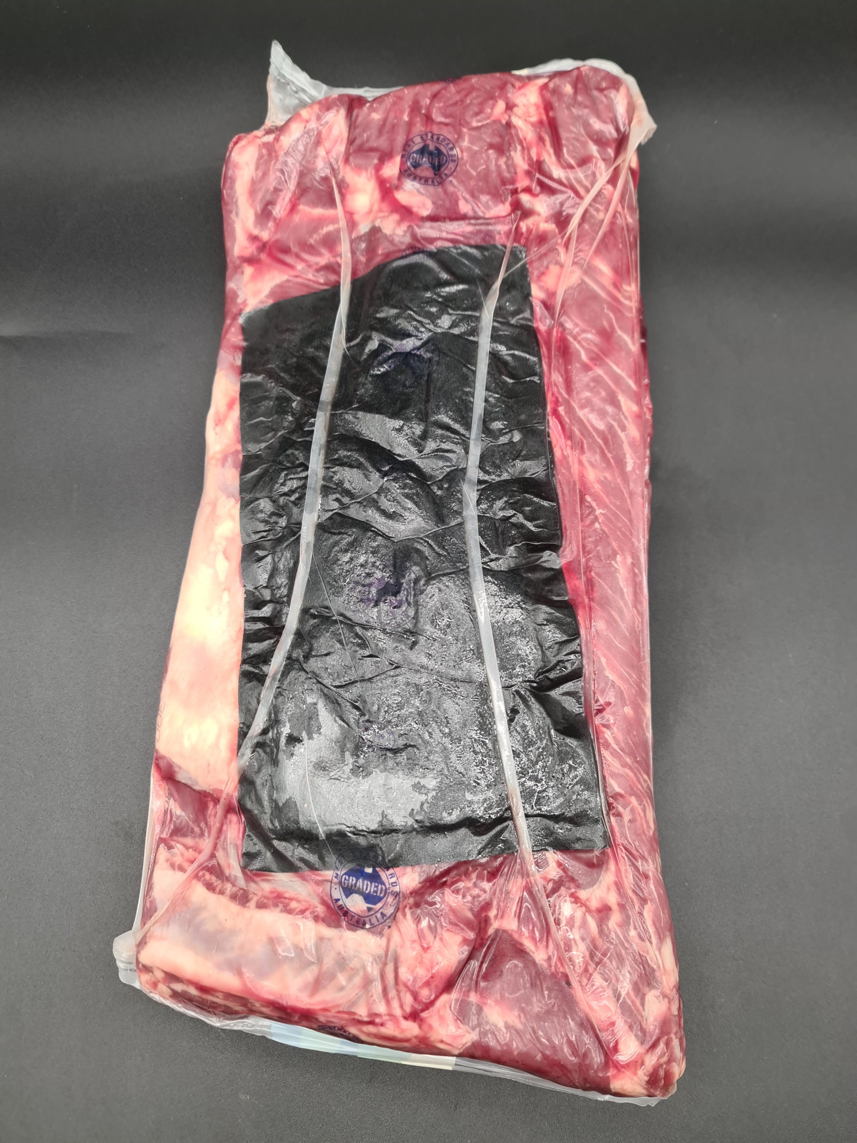 Angled premium beef cut showing lean meat and fat cap