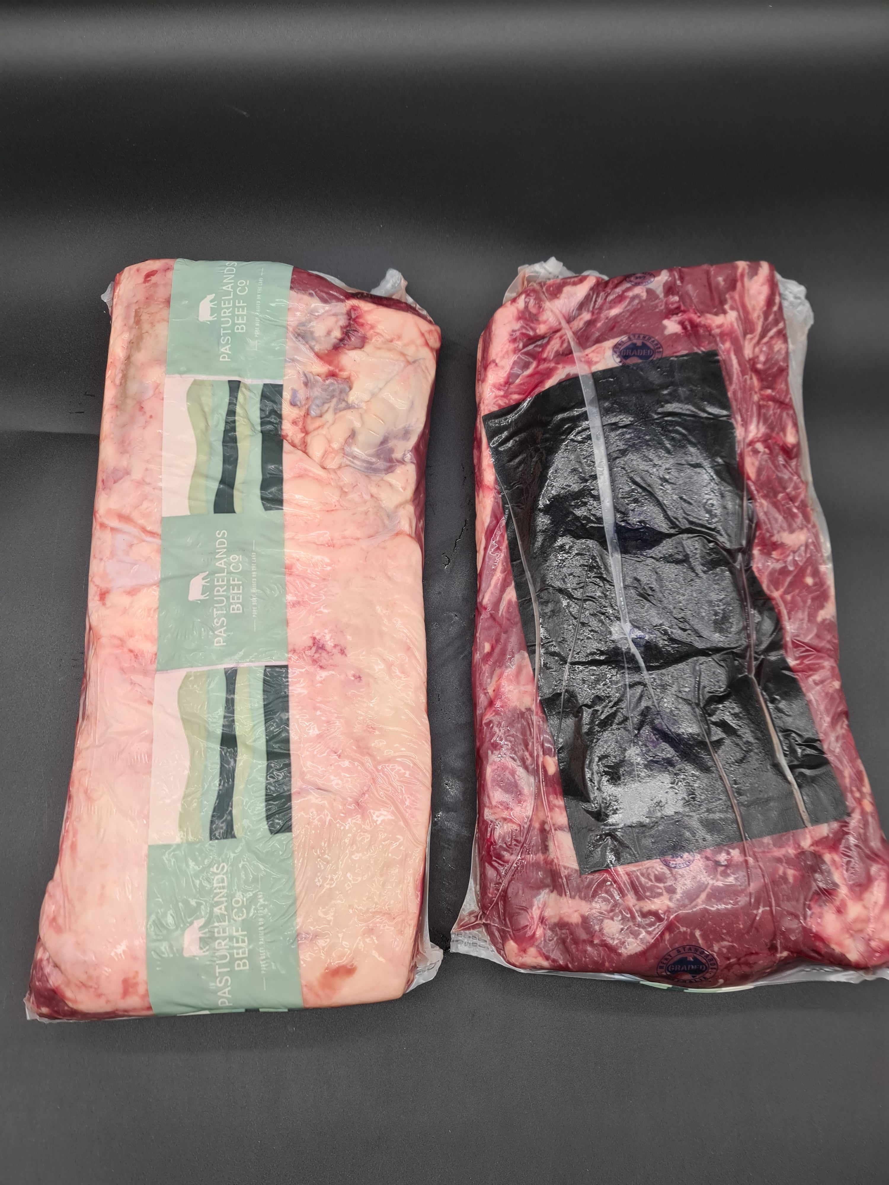 Two premium beef cuts side by side in vacuum packaging