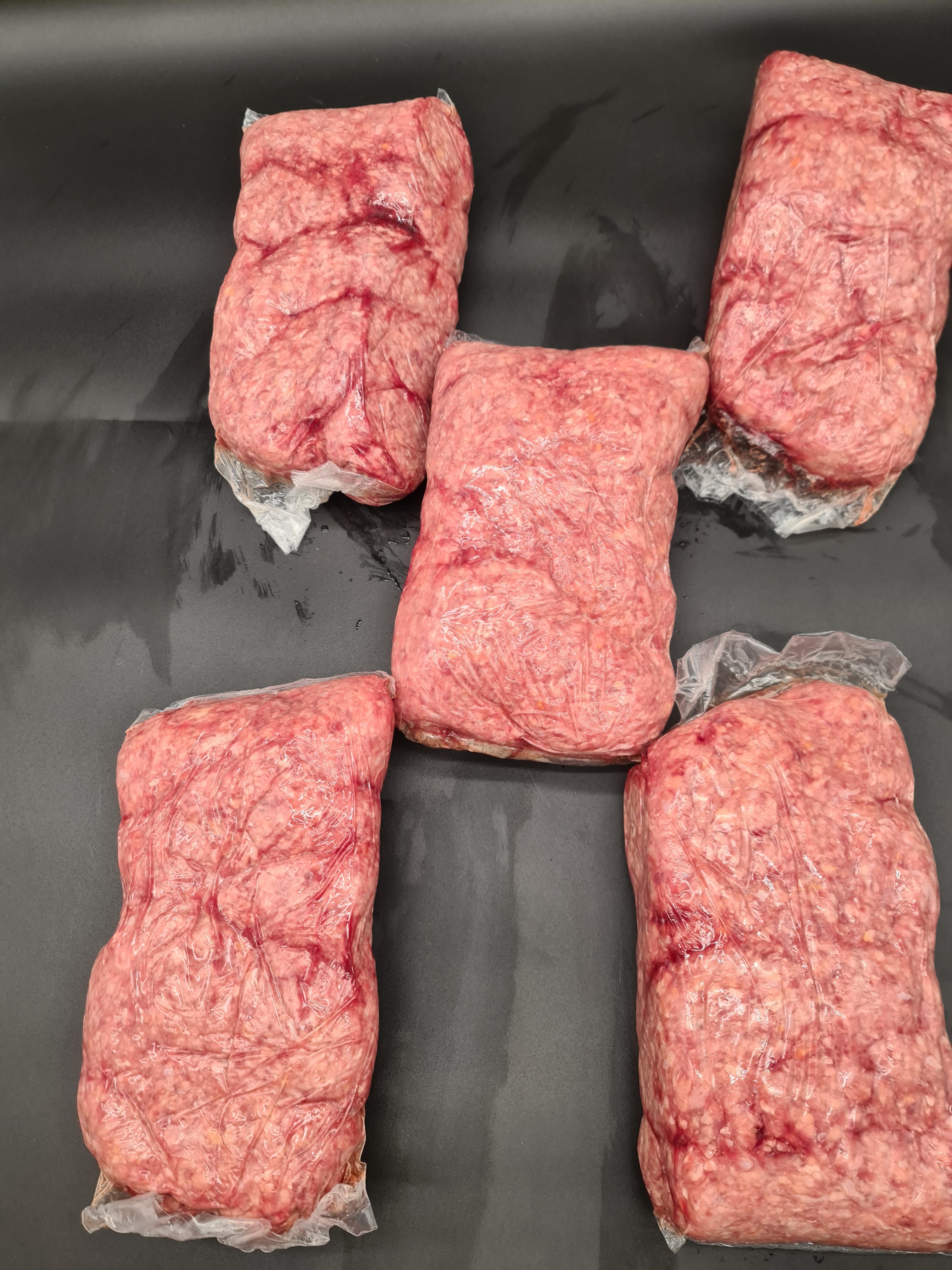 Open premium beef box with vacuum-packed cuts inside