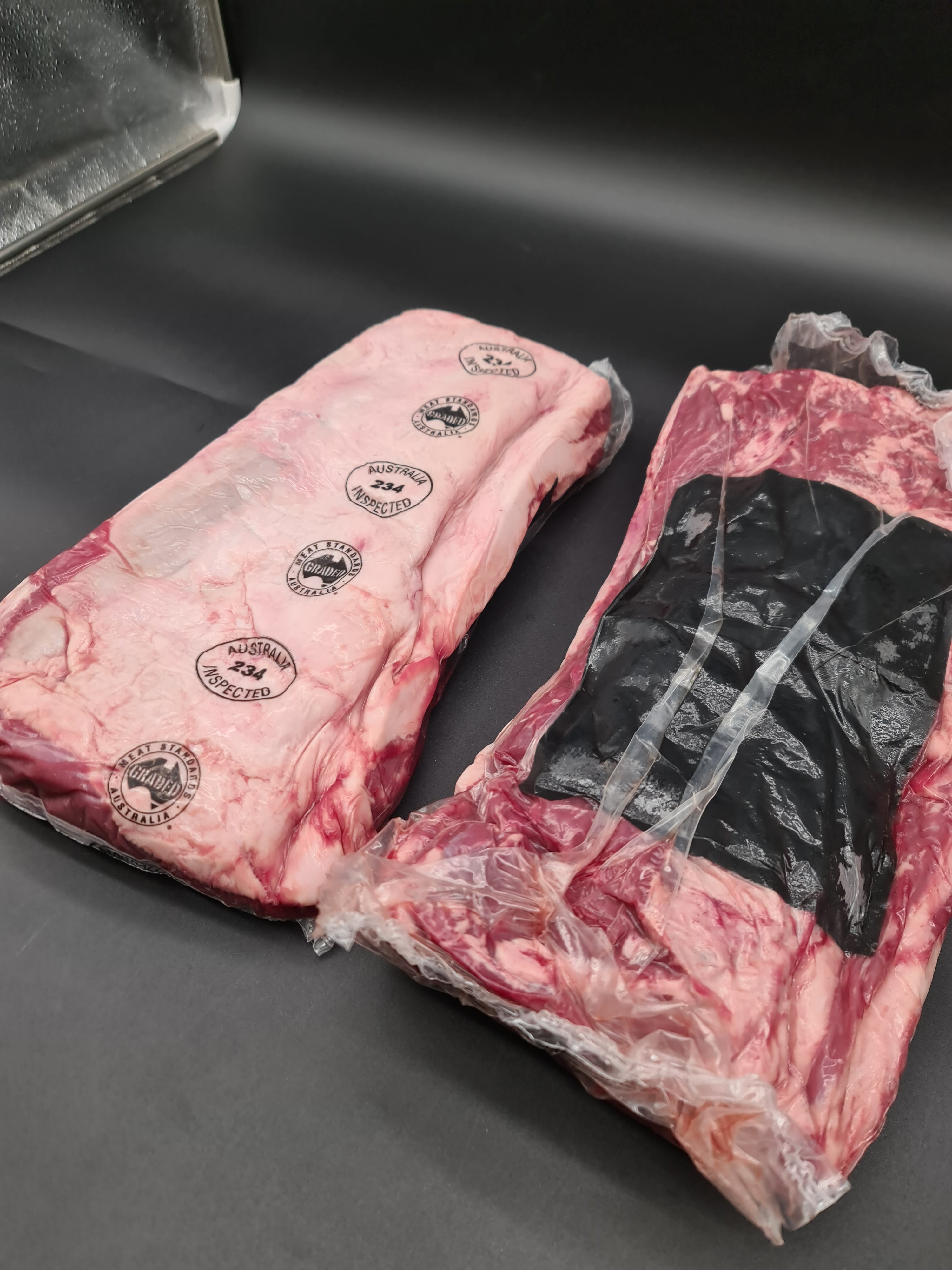 Open box filled with premium meat cuts in clear packaging
