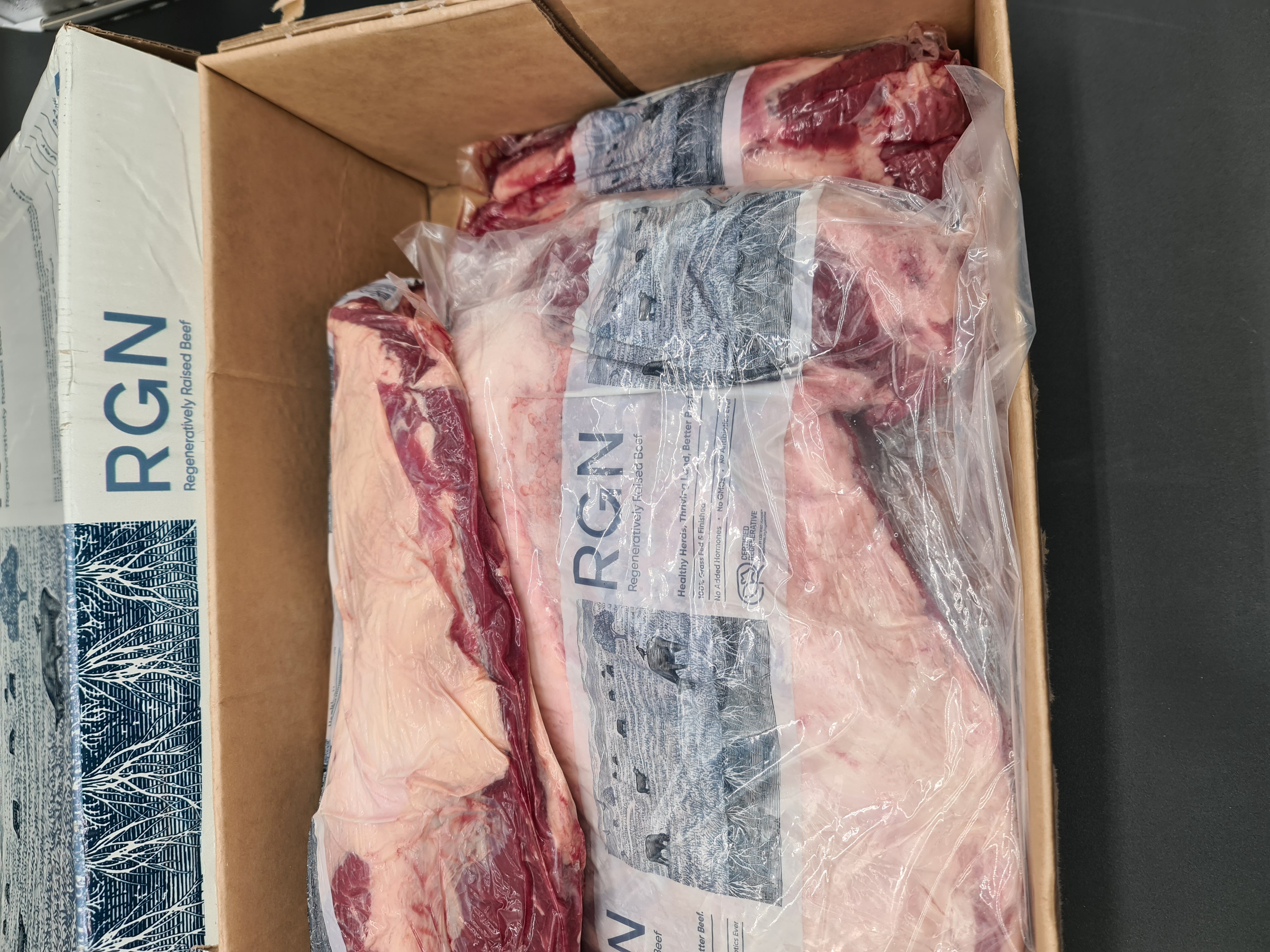 Vacuum-packed premium meat cut on a dark surface