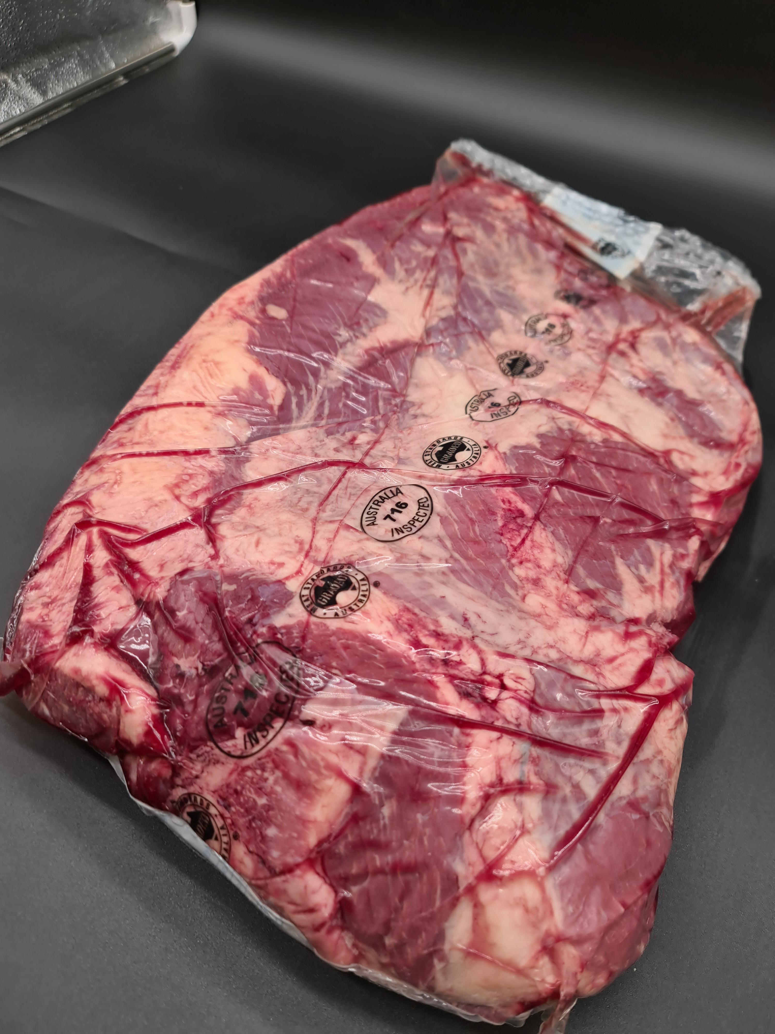 Open premium meat box filled with vacuum-packed cuts