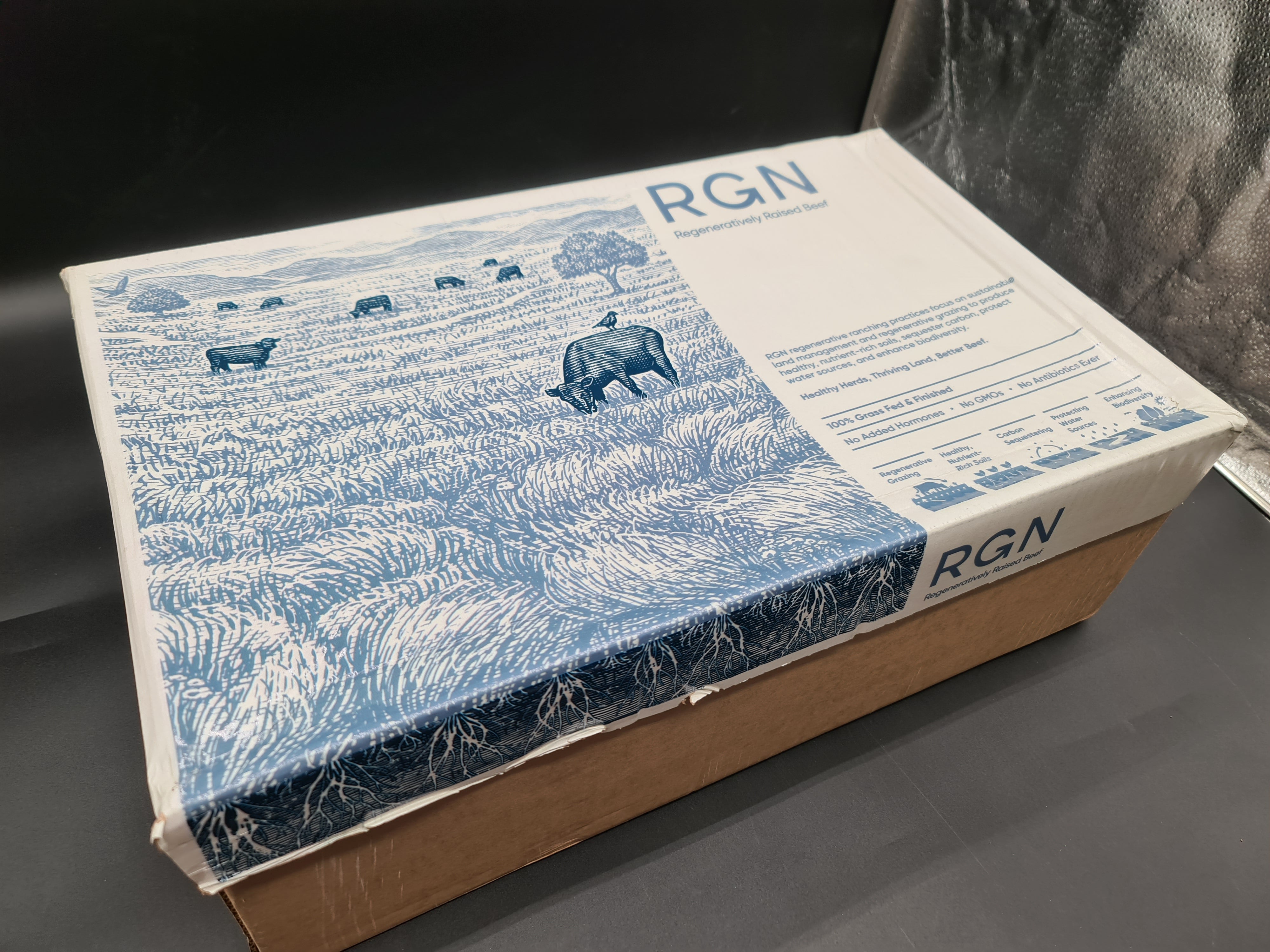 Open premium beef box with vacuum-packed cuts inside