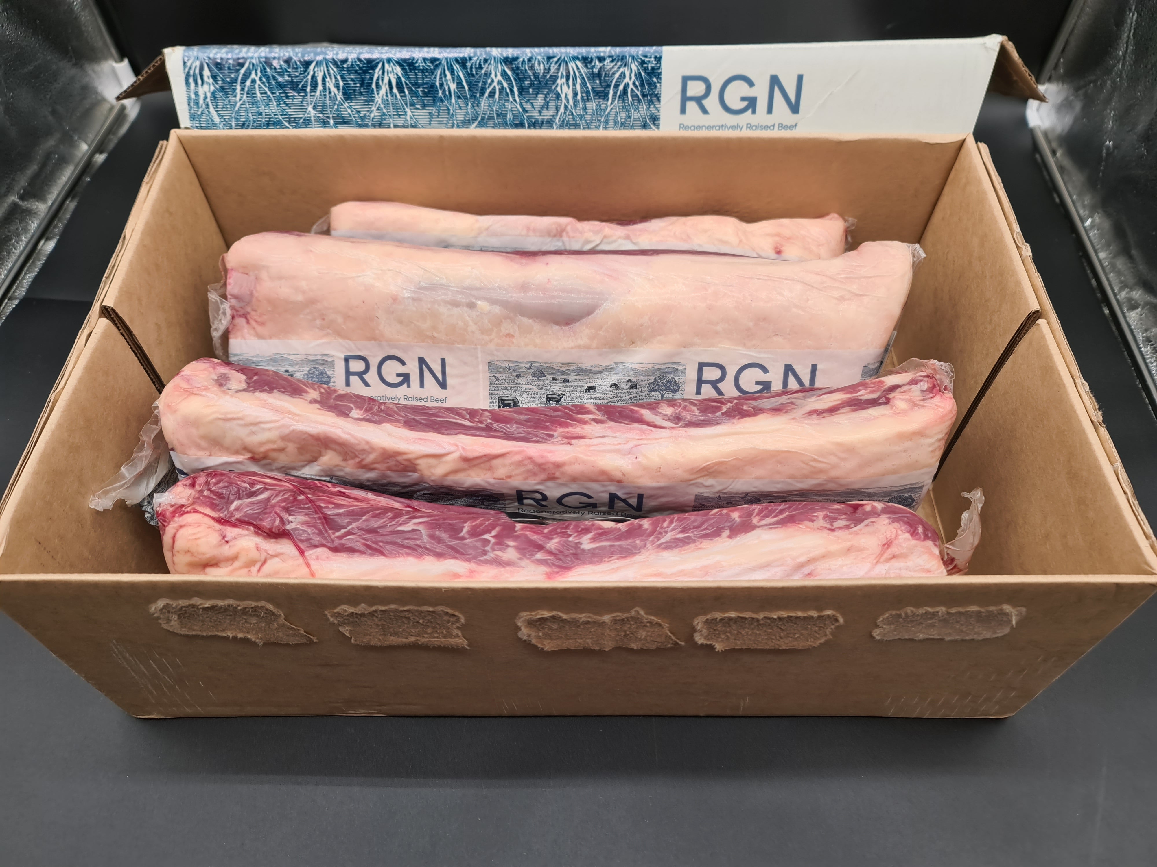Two premium meat cuts side by side in vacuum packaging