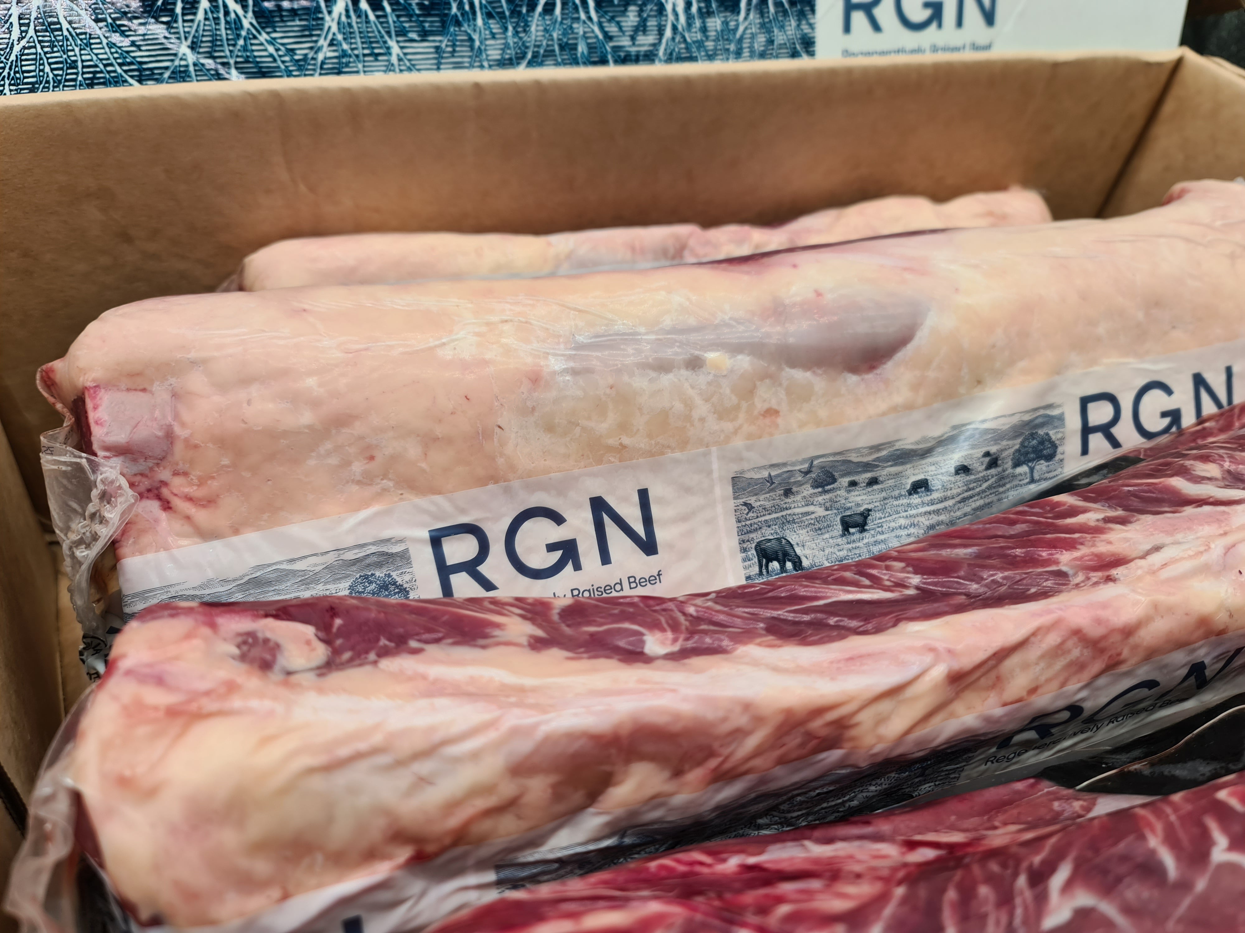 Vacuum-packed premium meat cut on a dark surface