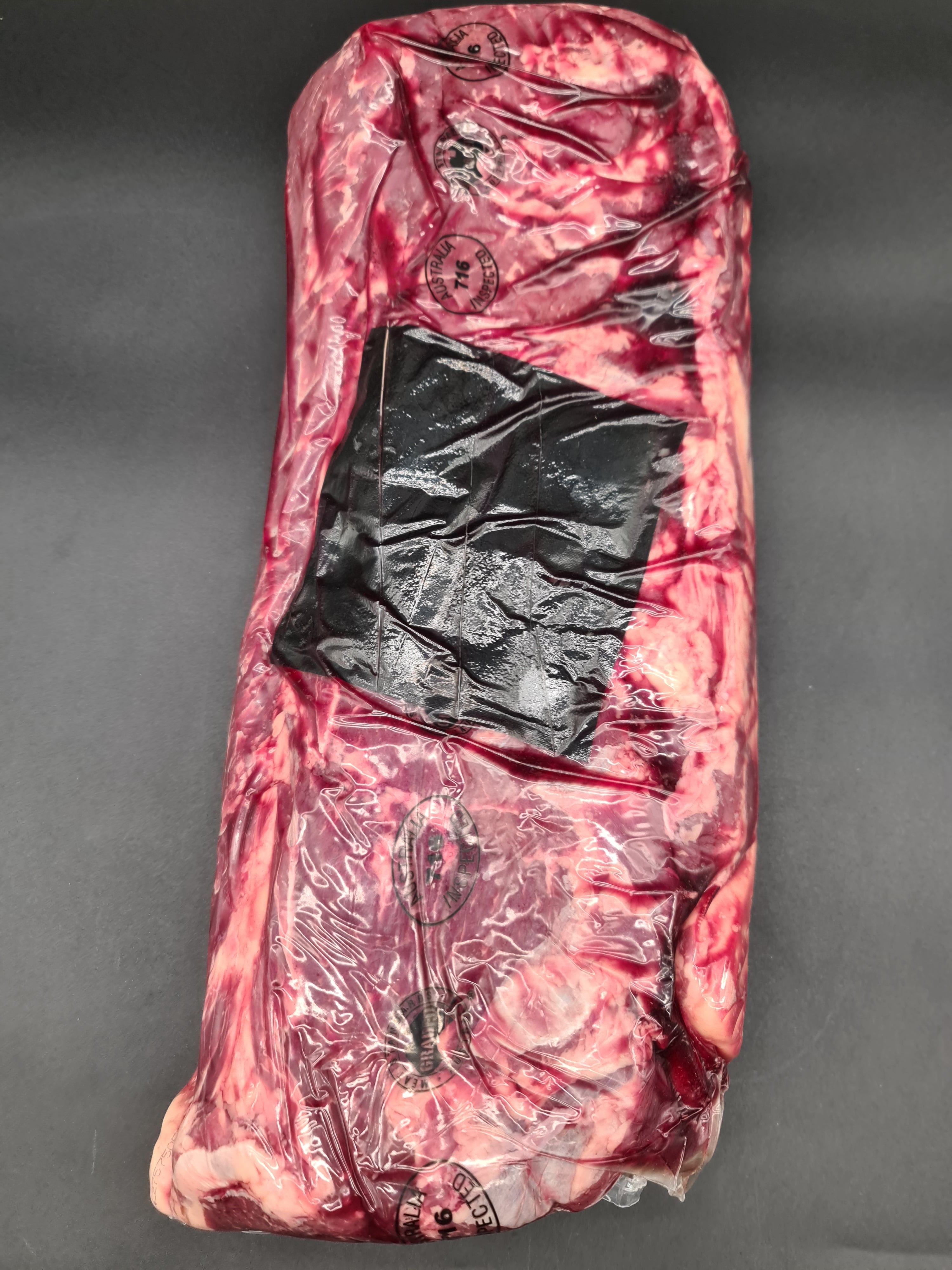 Closed premium meat box on a dark studio surface