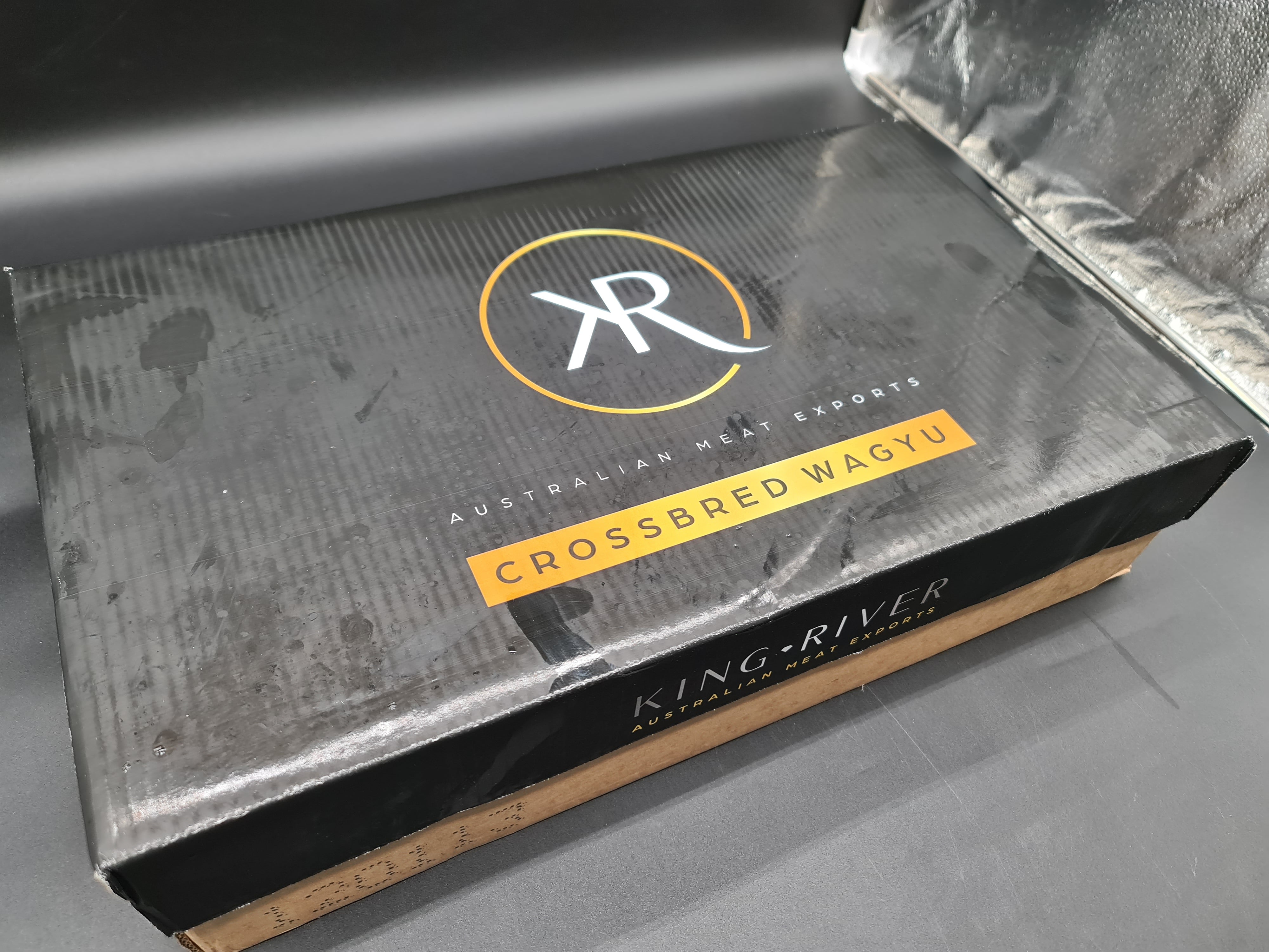 Angled view of premium meat cuts inside an open box