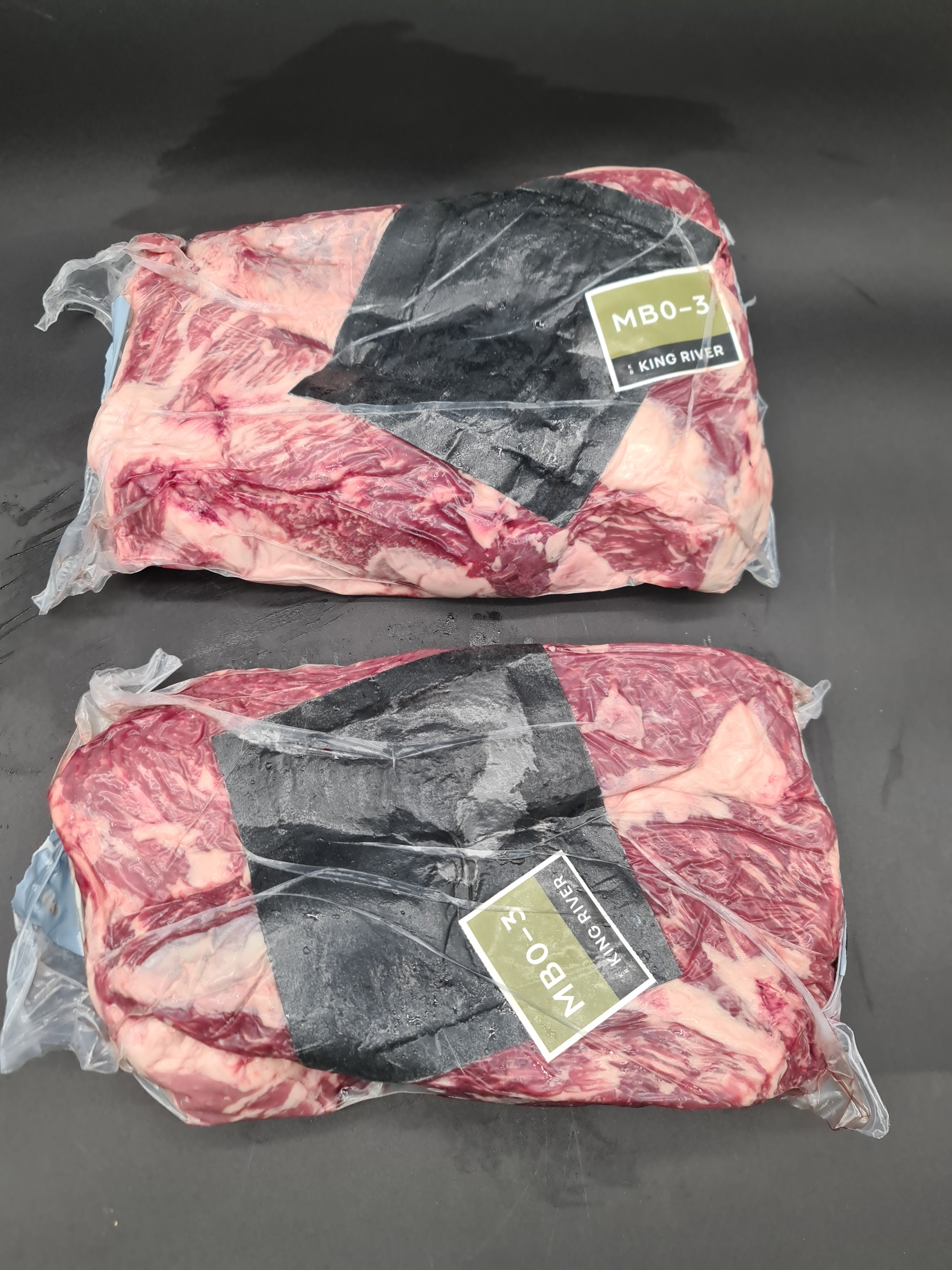 Close-up of branded meat cuts packed in a box