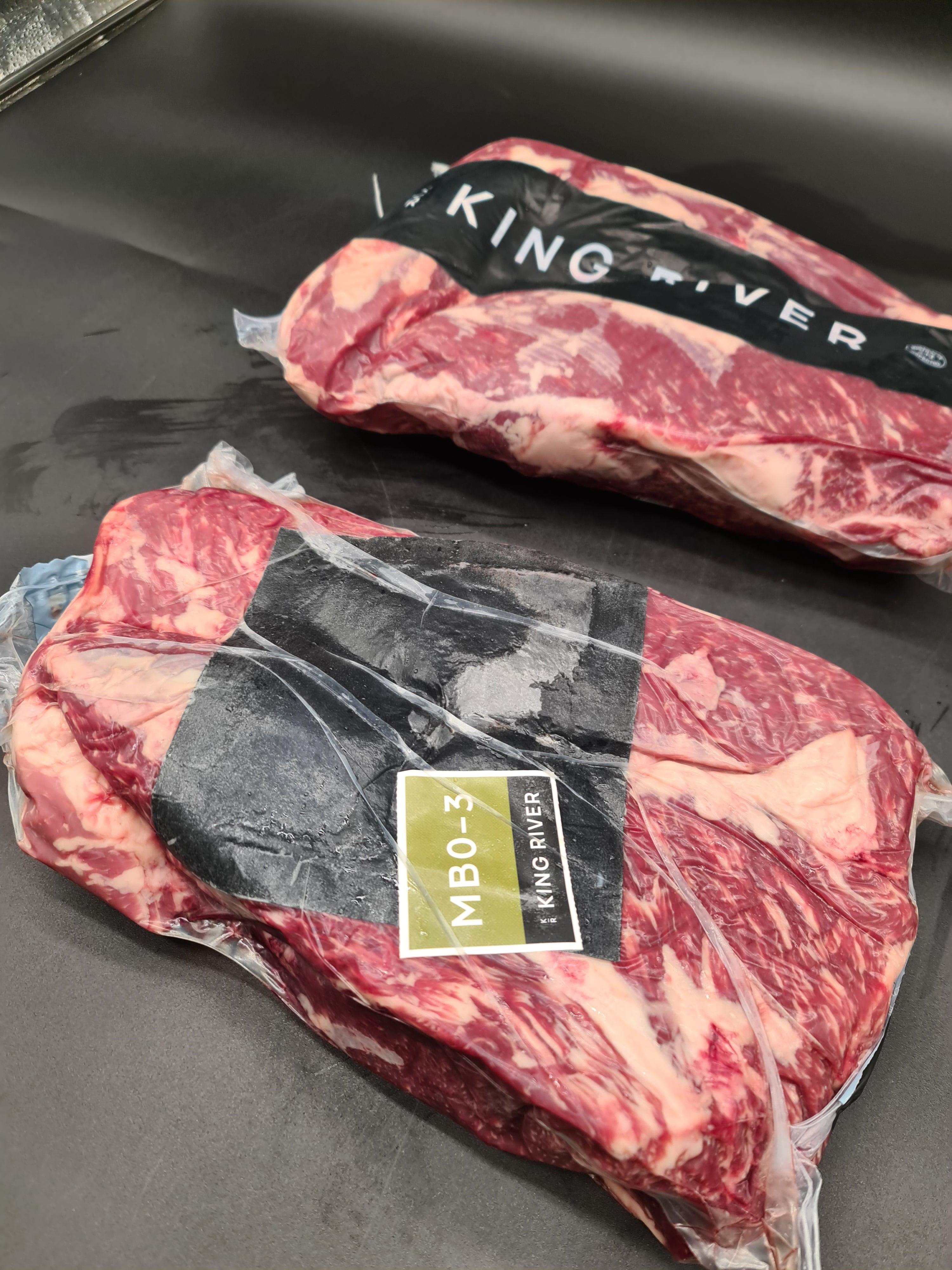 Two premium meat cuts side by side in clear packaging