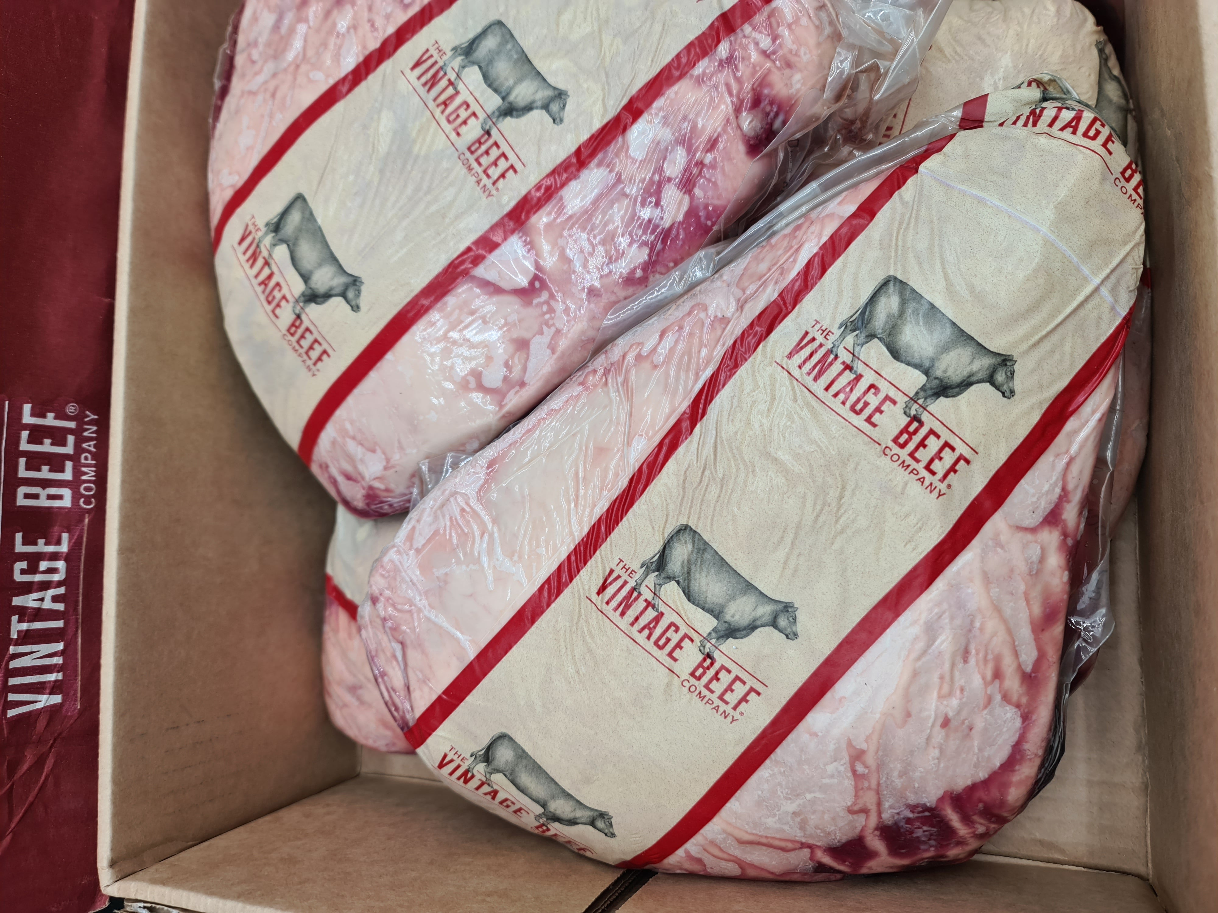 Vacuum-packed premium meat cut on dark studio surface