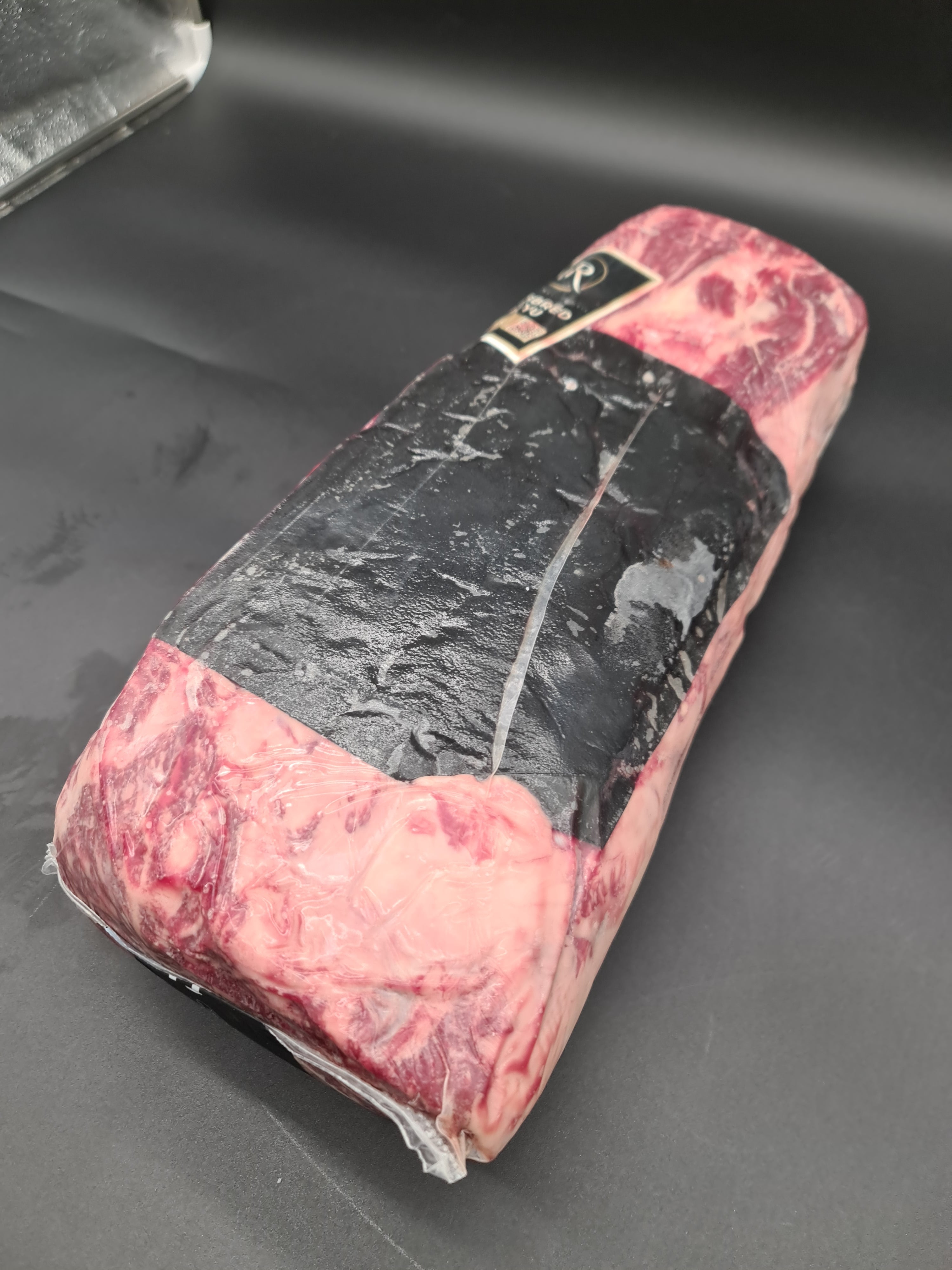 Angled premium beef cut showing visible fat cap