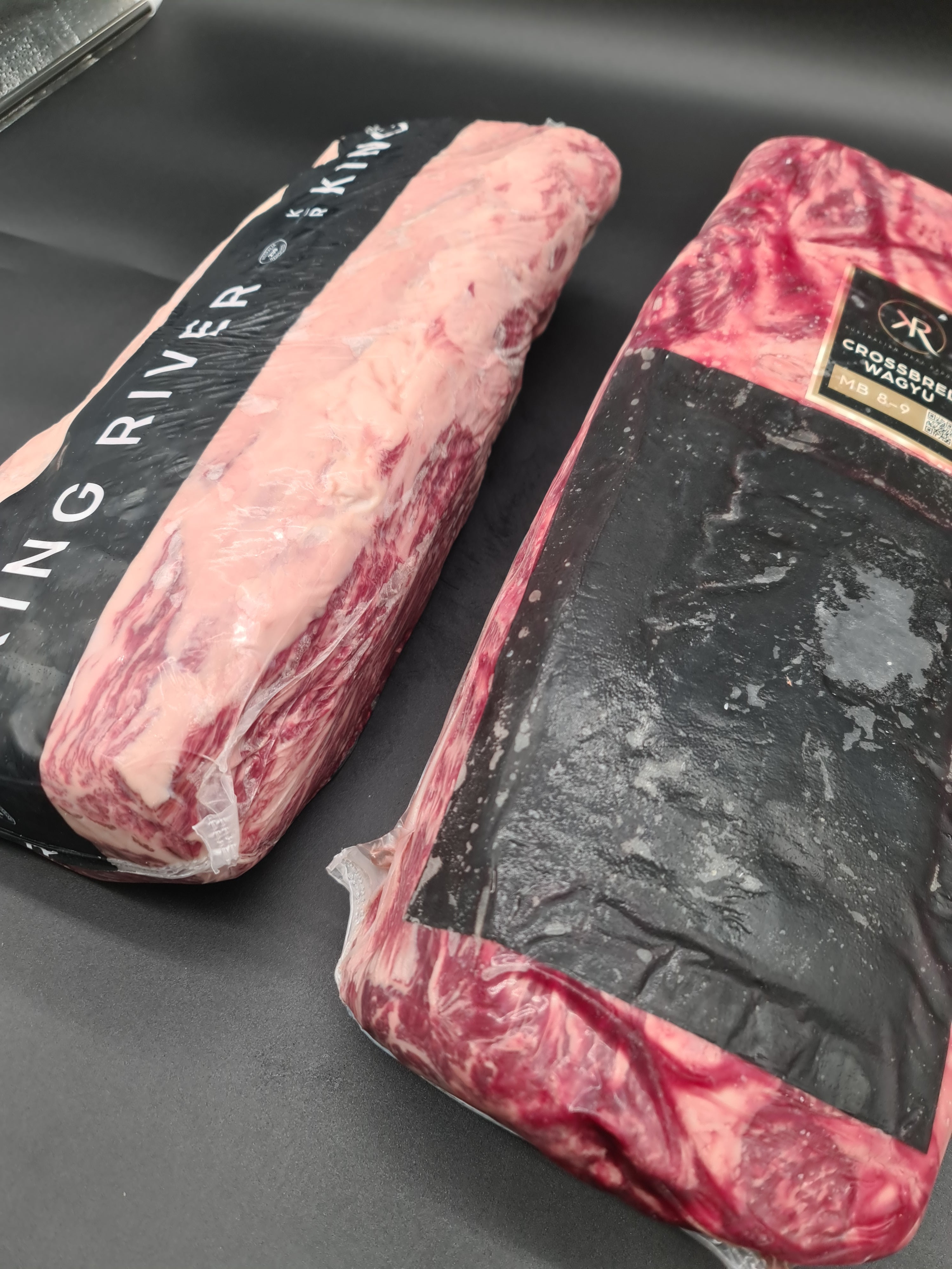 Close-up of two premium beef cuts in clear packaging