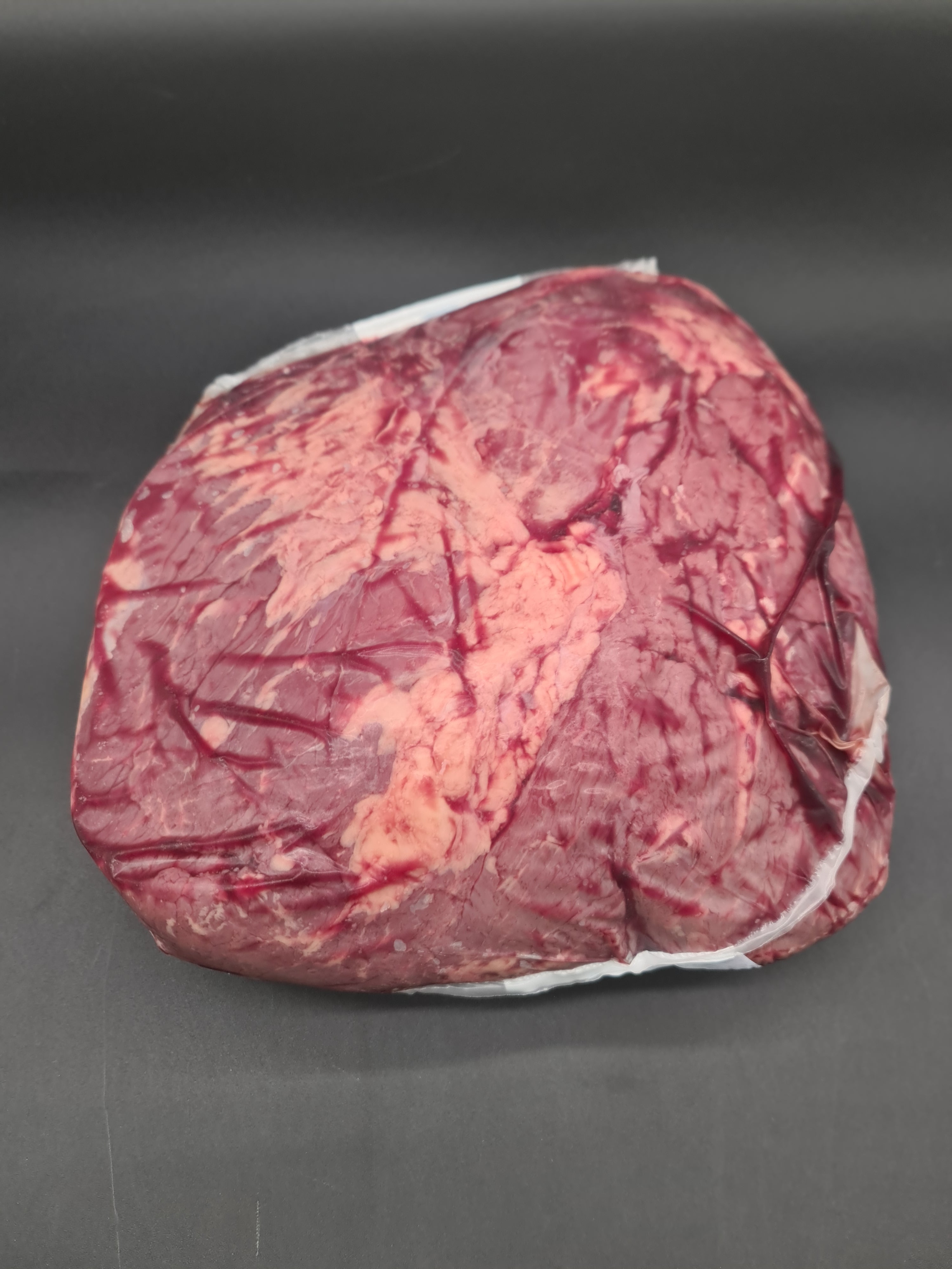 Open box filled with vacuum-packed premium meat cuts