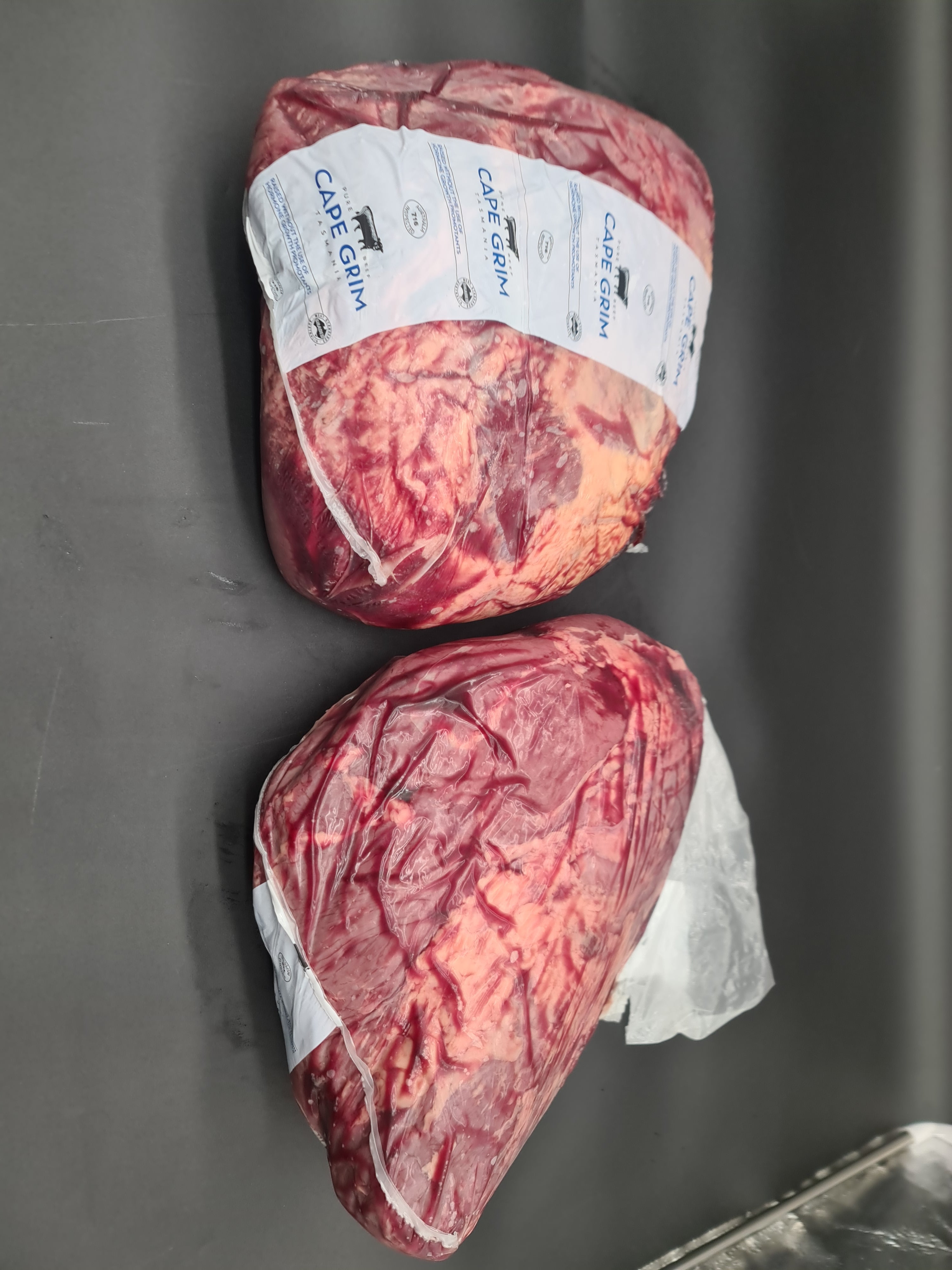 Angled view of packed premium meat cuts in a box