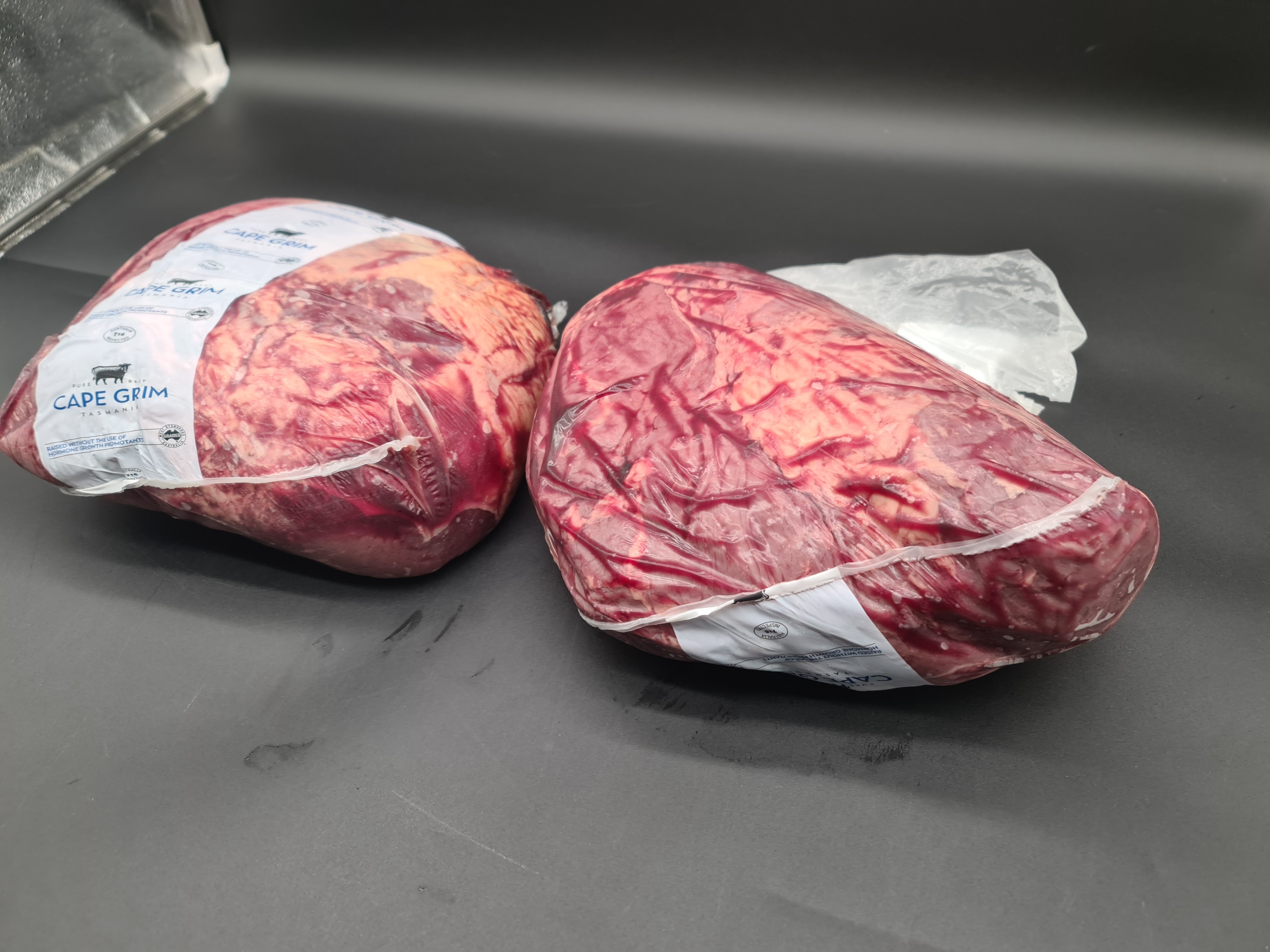 Closed premium meat box on a dark studio surface