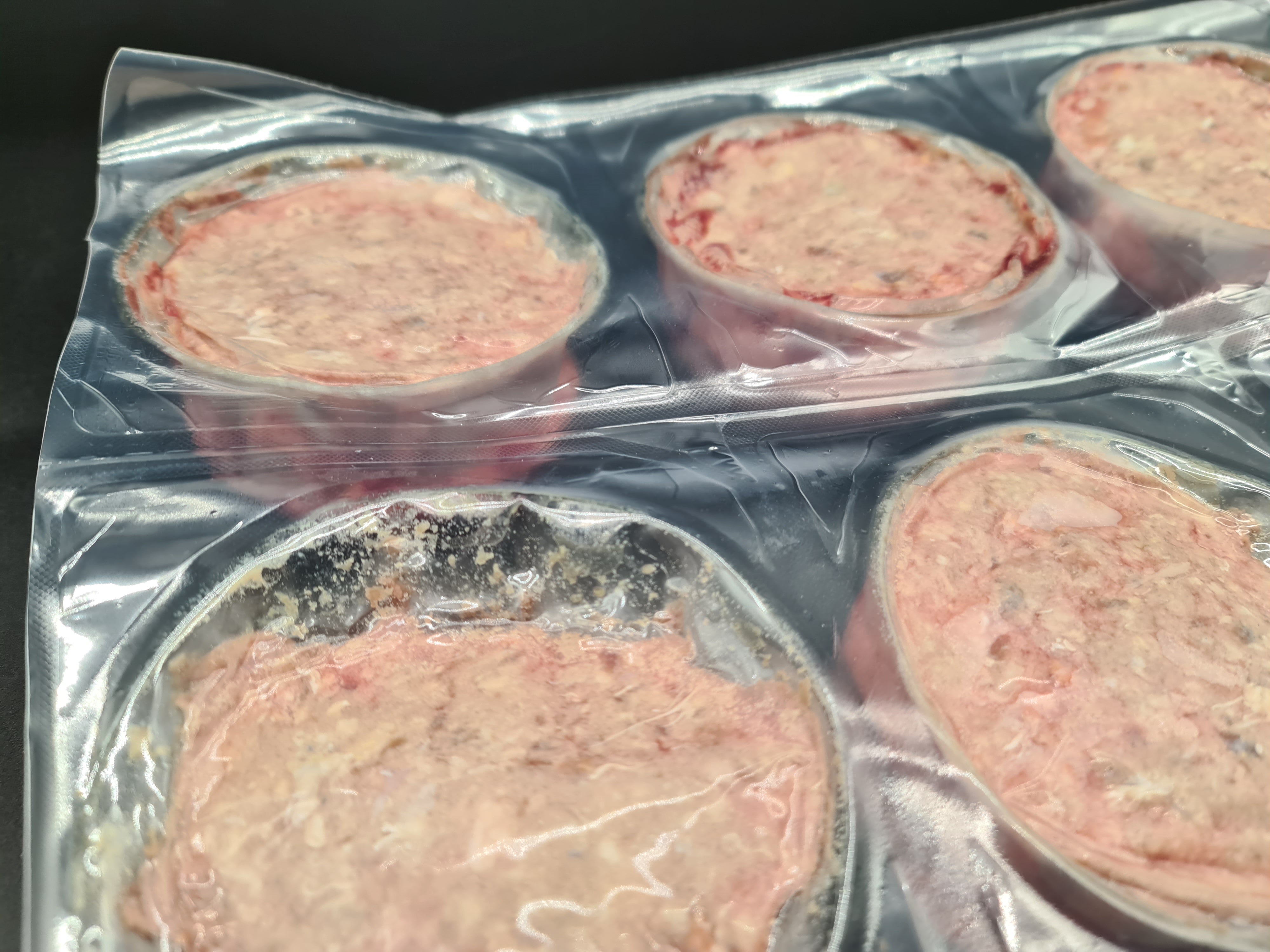 Open box filled with vacuum-packed premium meat cuts