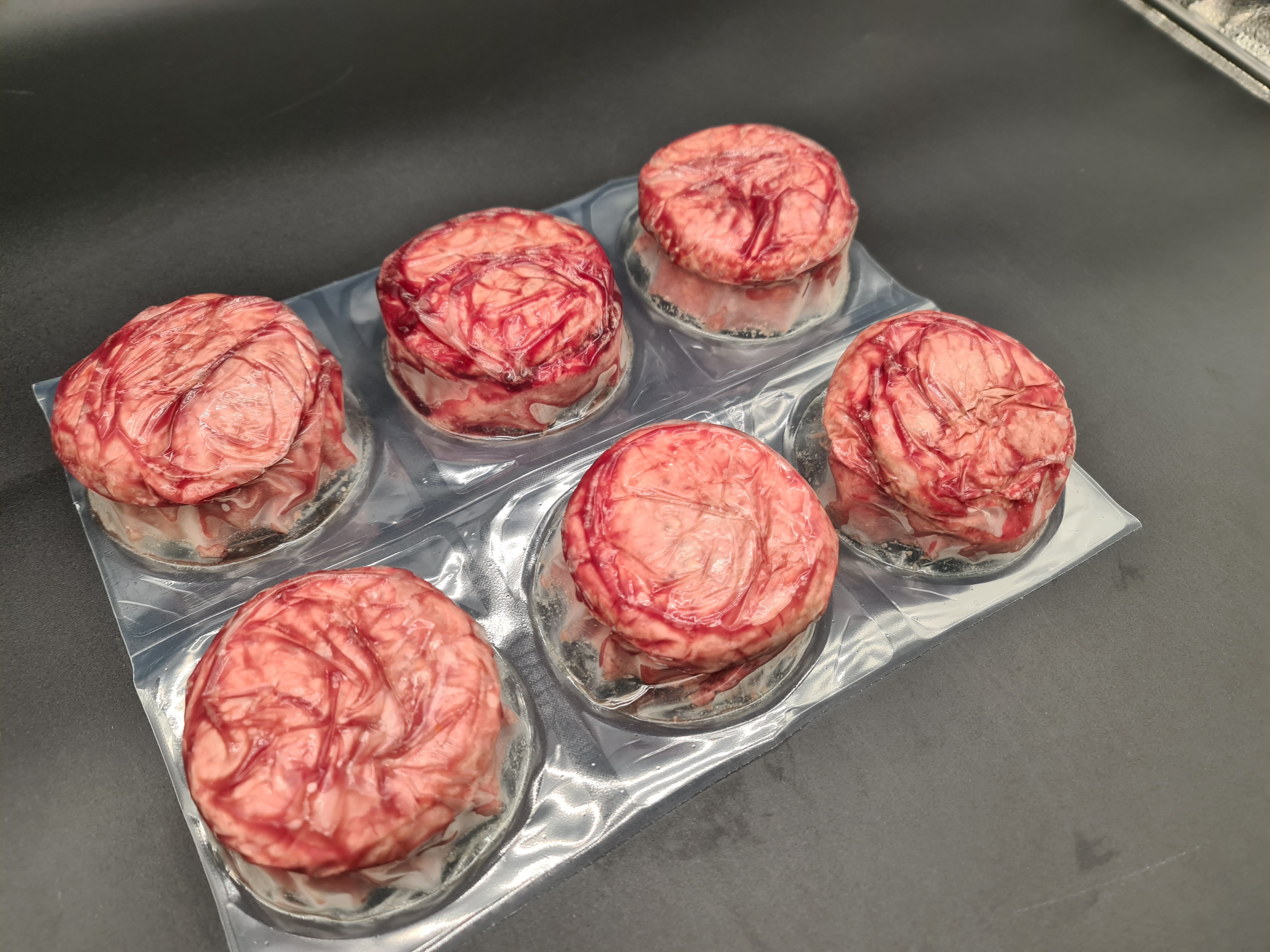 Close-up of two premium meat cuts with visible fat caps
