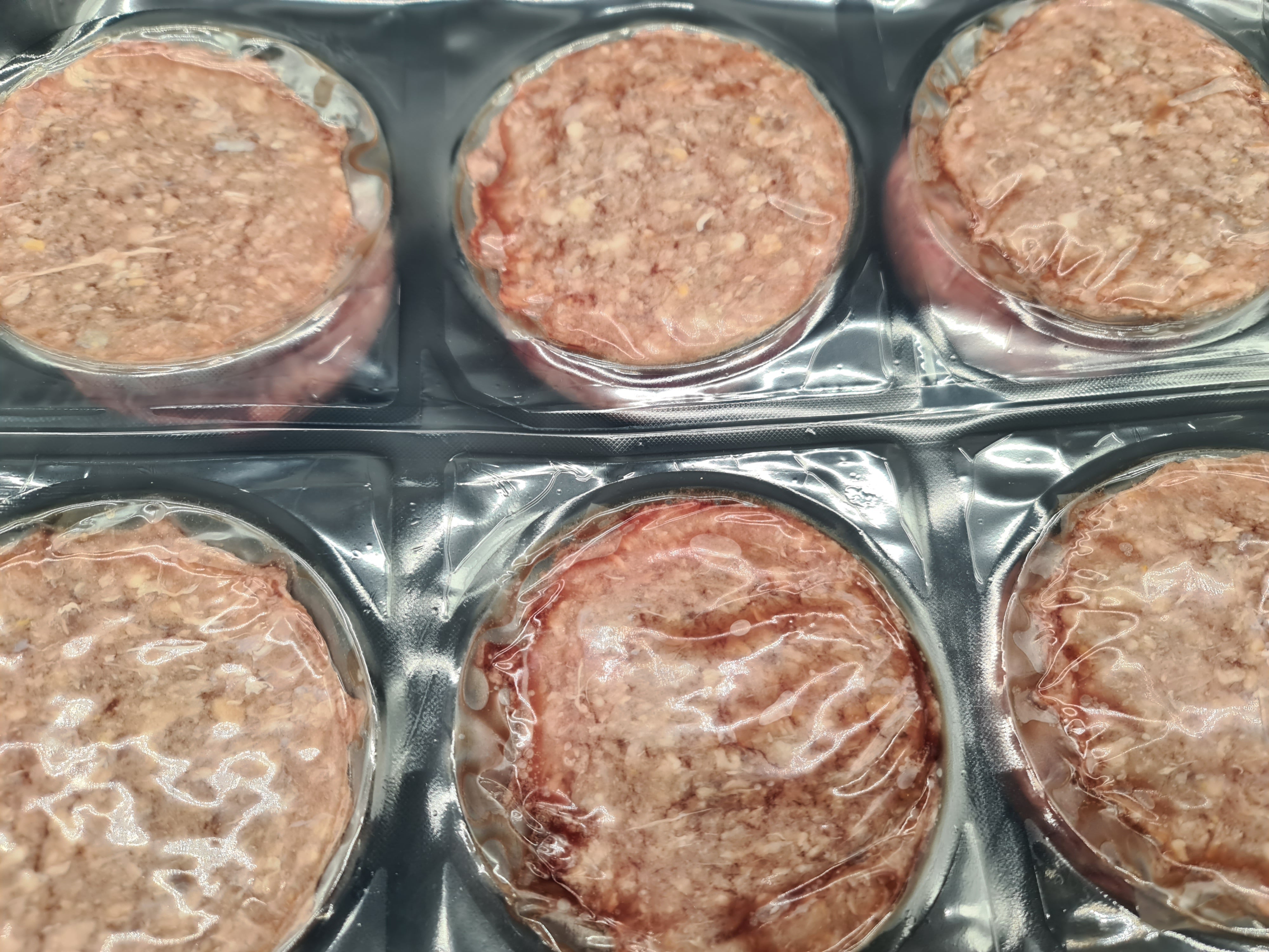 Two premium meat cuts side by side in vacuum packaging