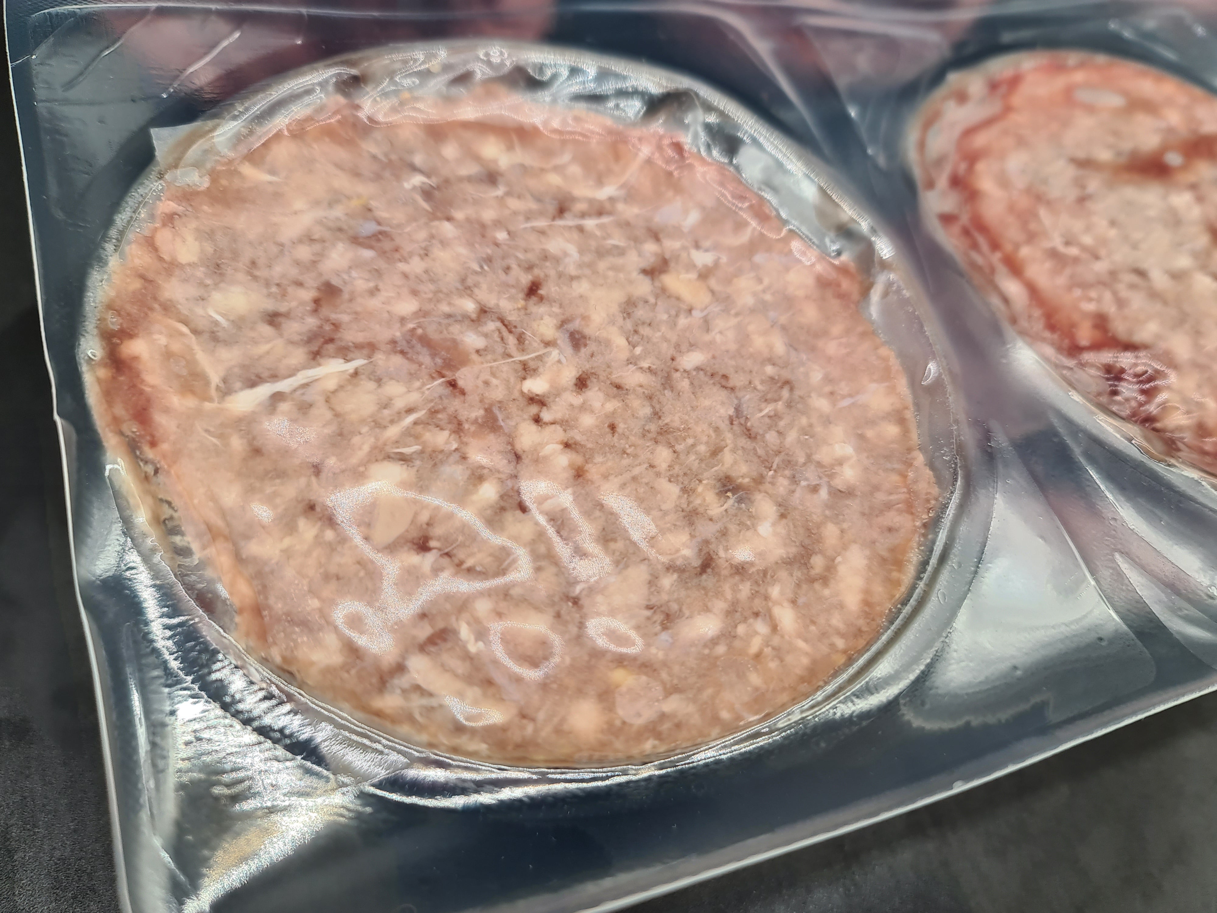 Close-up of two premium meat cuts with visible fat caps