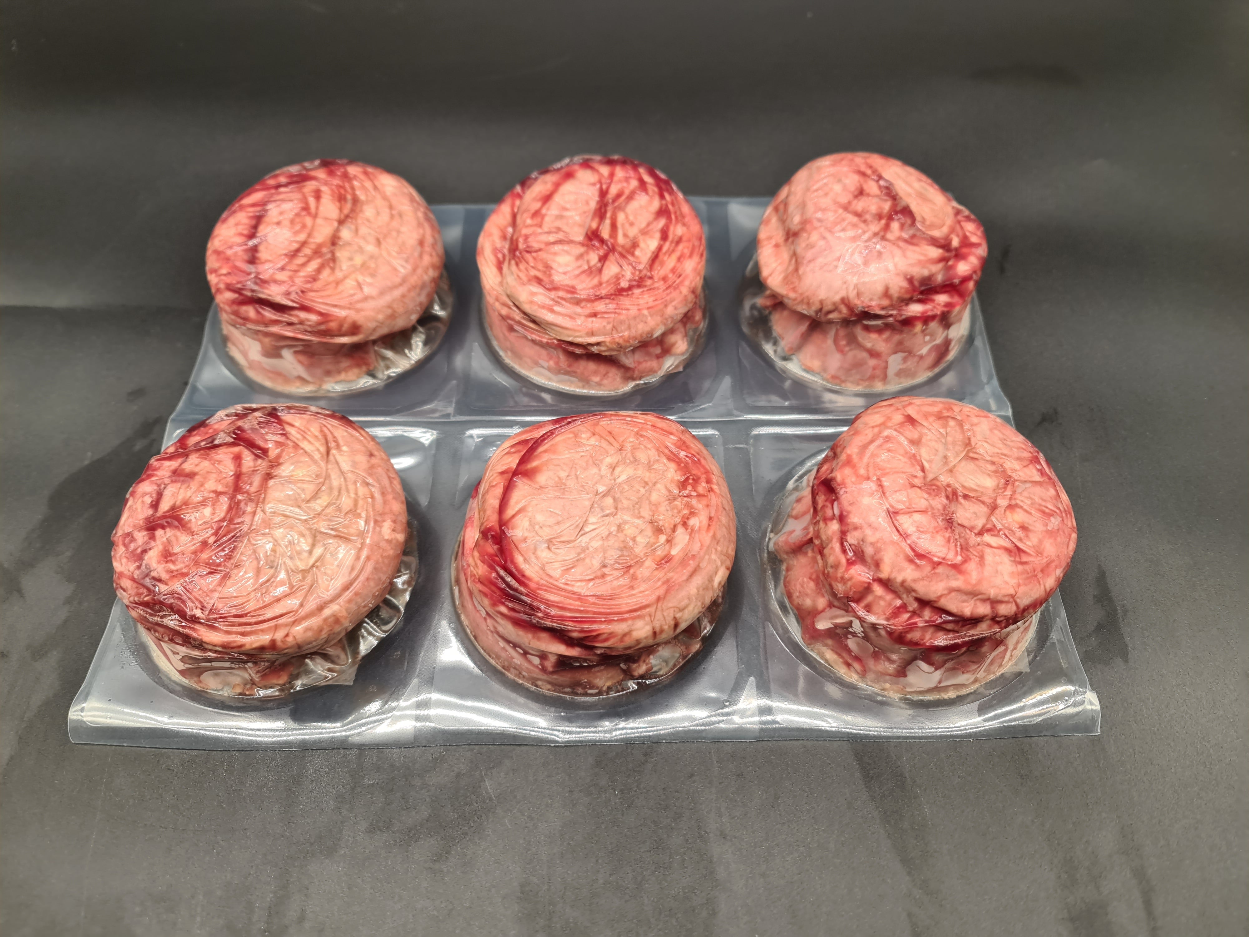 Open box filled with vacuum-packed premium meat cuts