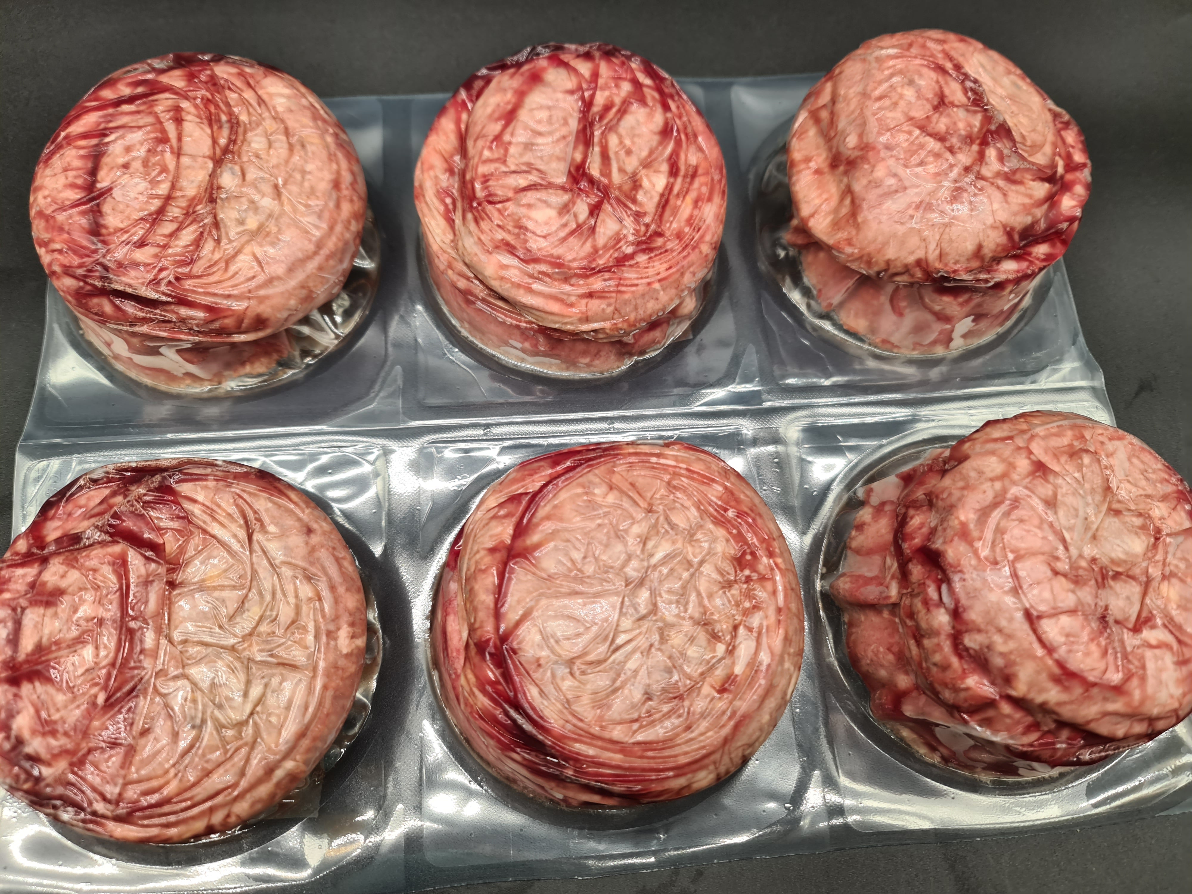 Closed premium meat box on a dark studio surface