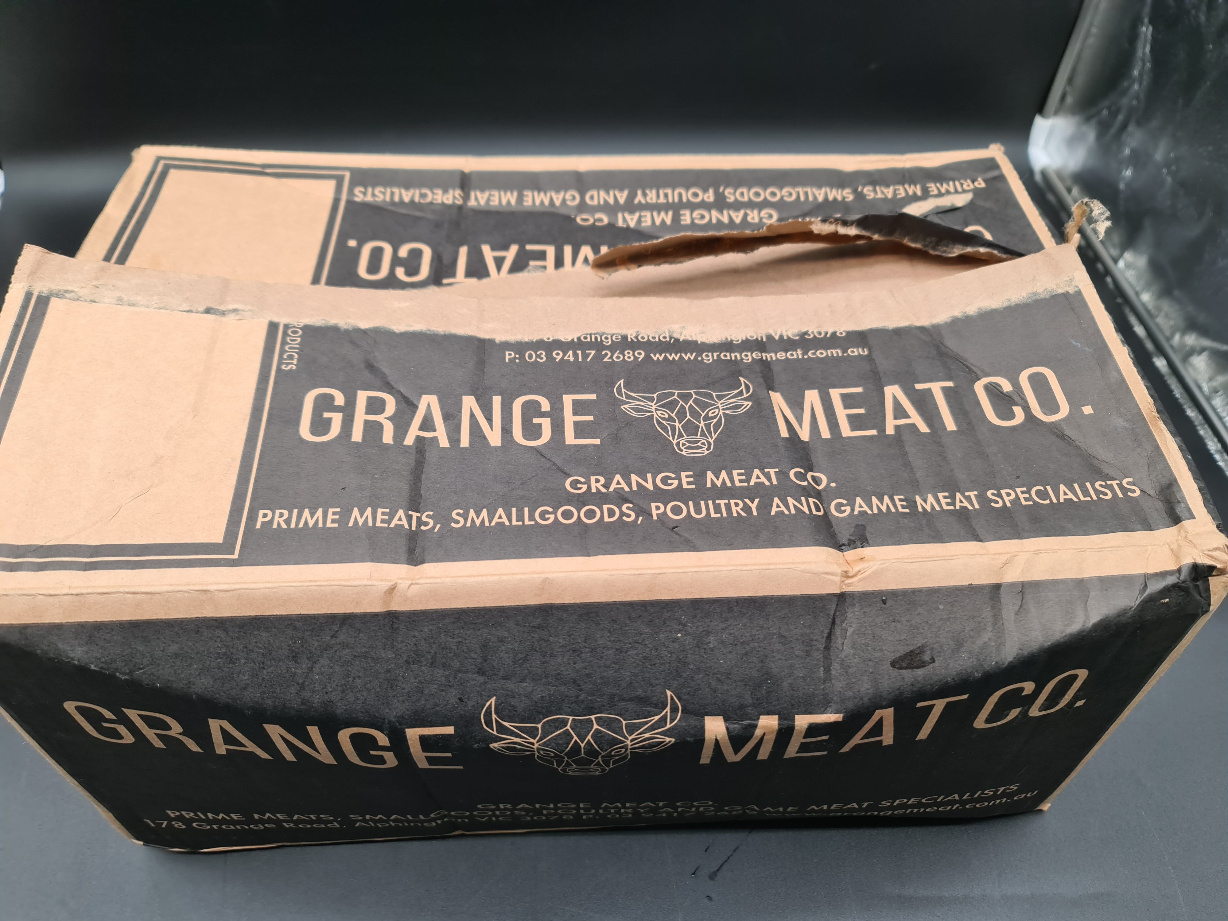 Open premium meat box with vacuum-packed cuts inside