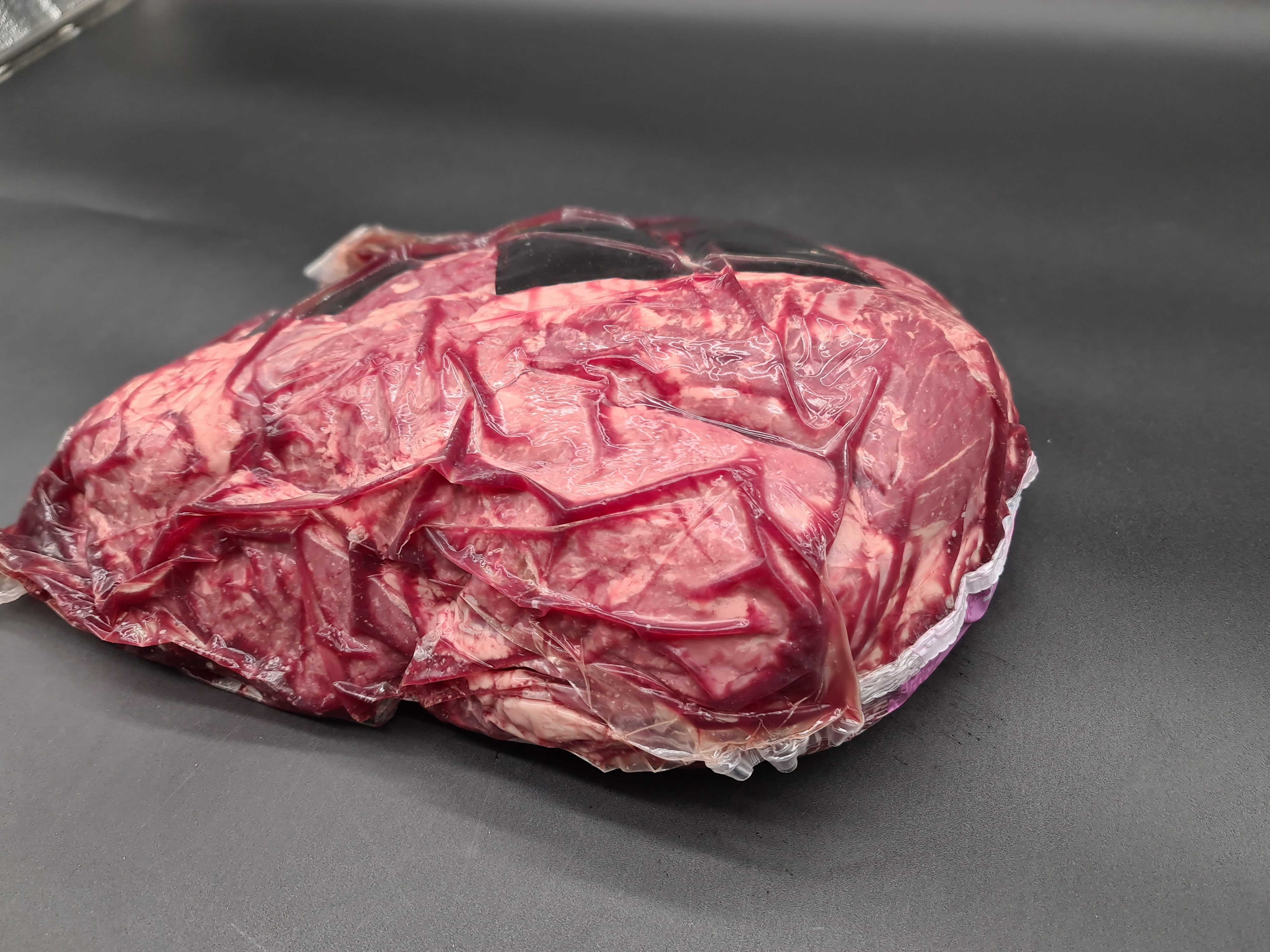 Open box filled with vacuum-packed premium meat cuts