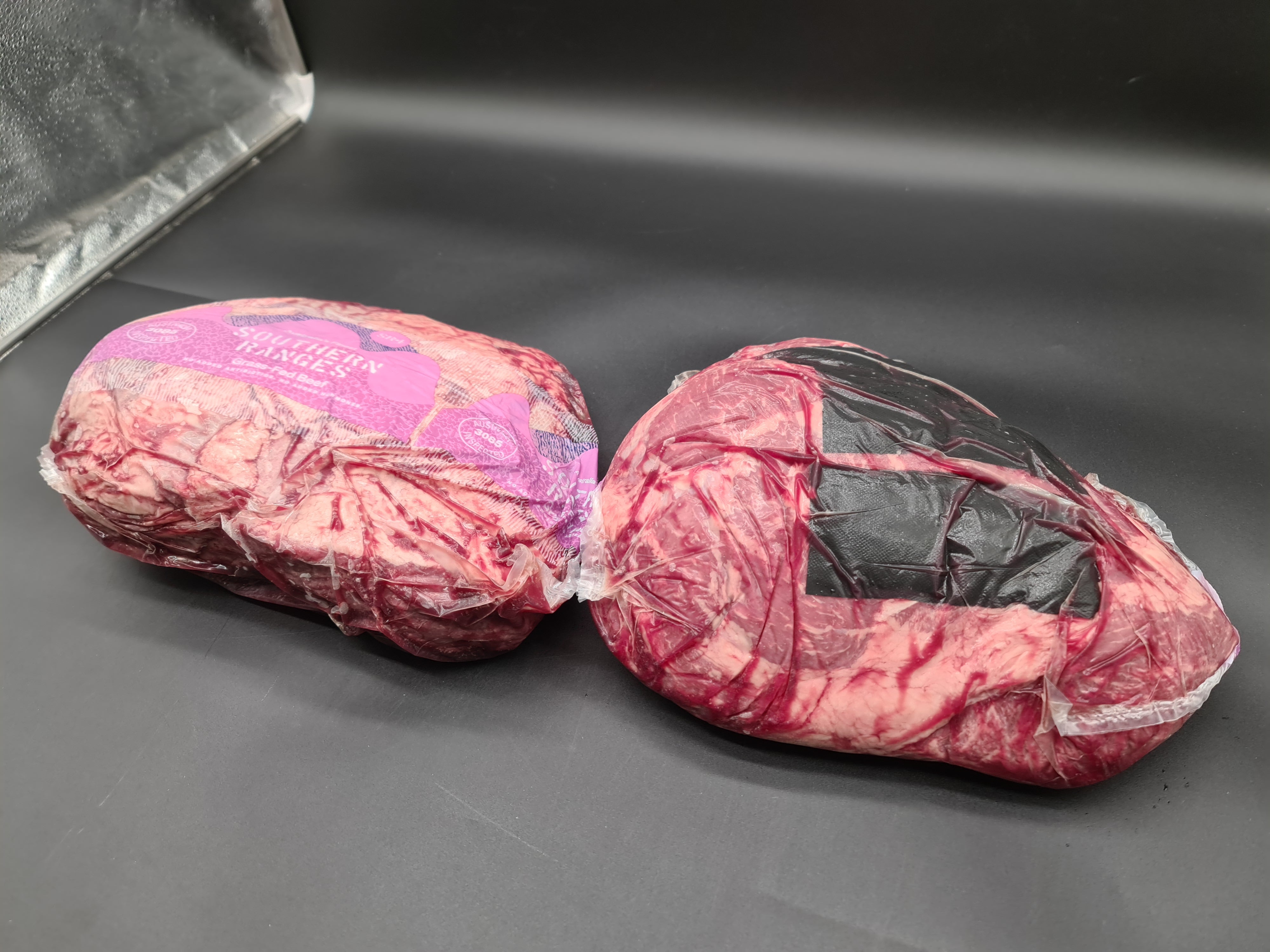 Closed premium meat box on a dark studio surface