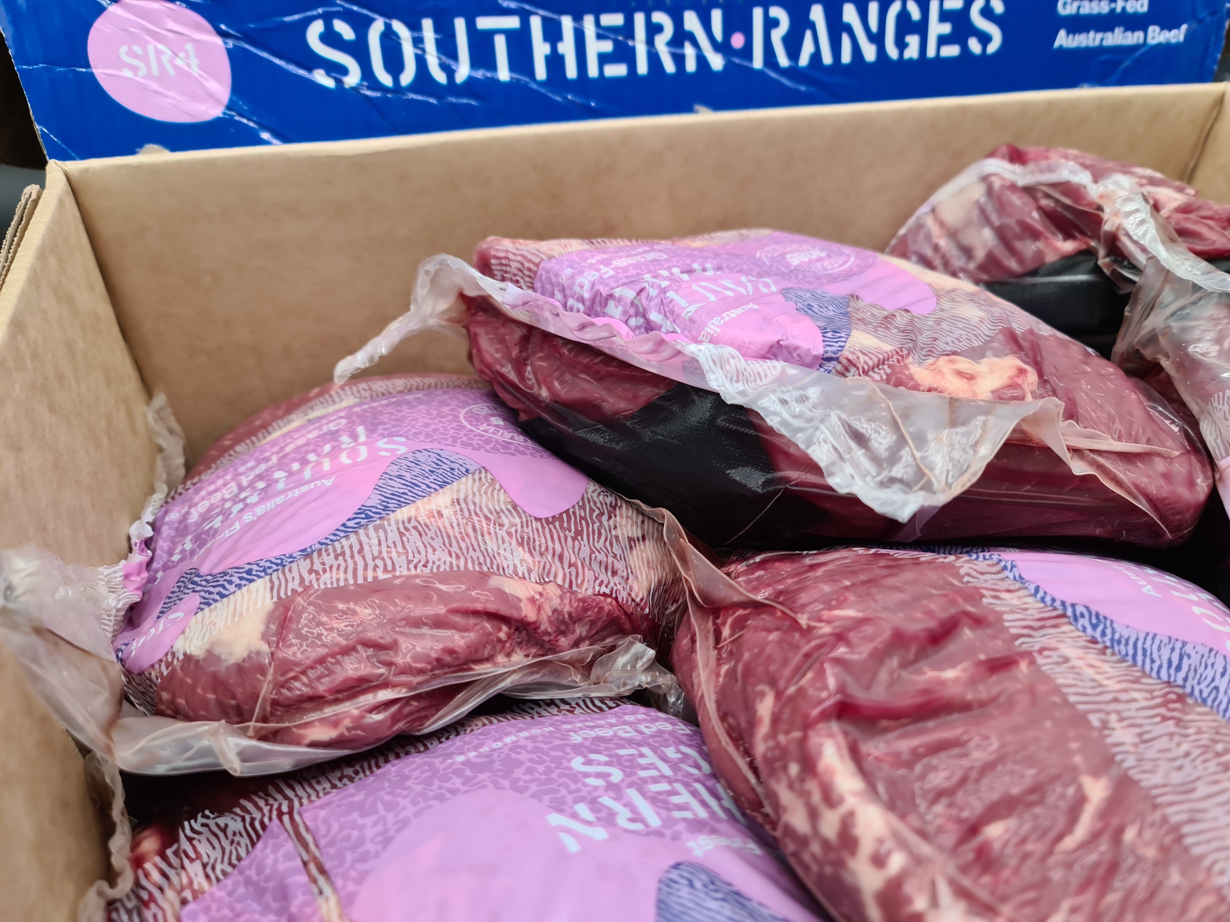 Open premium meat box with vacuum-packed cuts inside