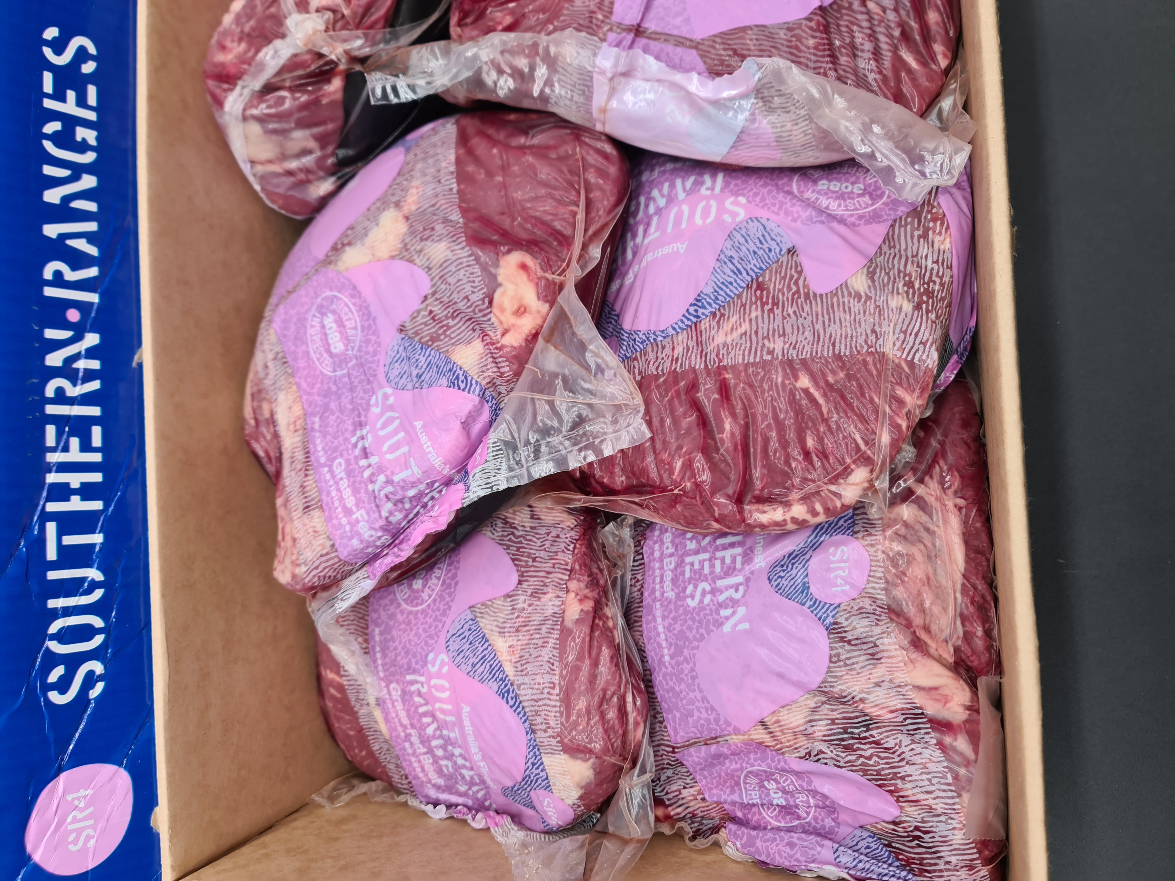 Vacuum-packed premium meat cut on a dark surface
