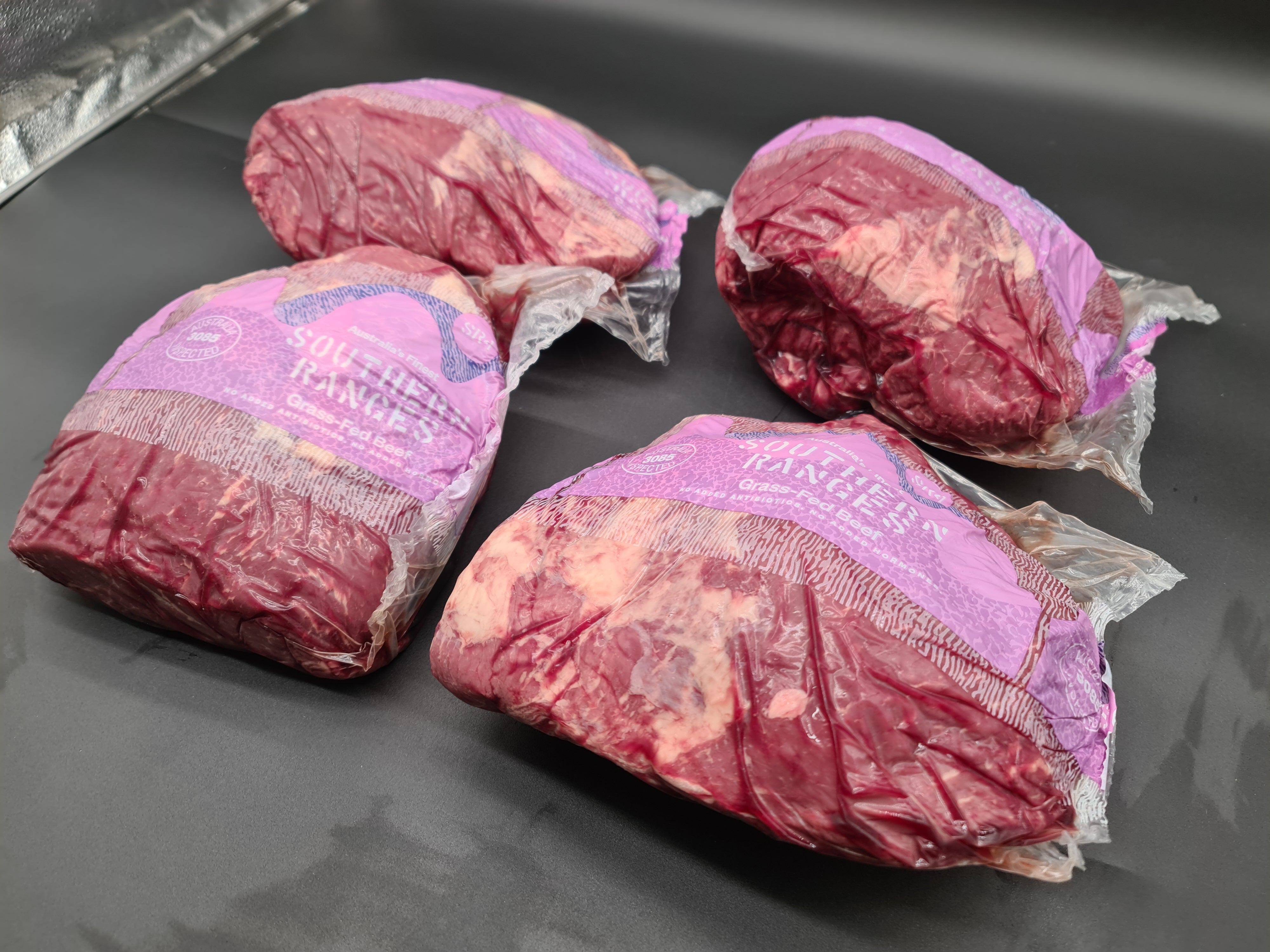 Close-up of premium meat cuts packed in an open box