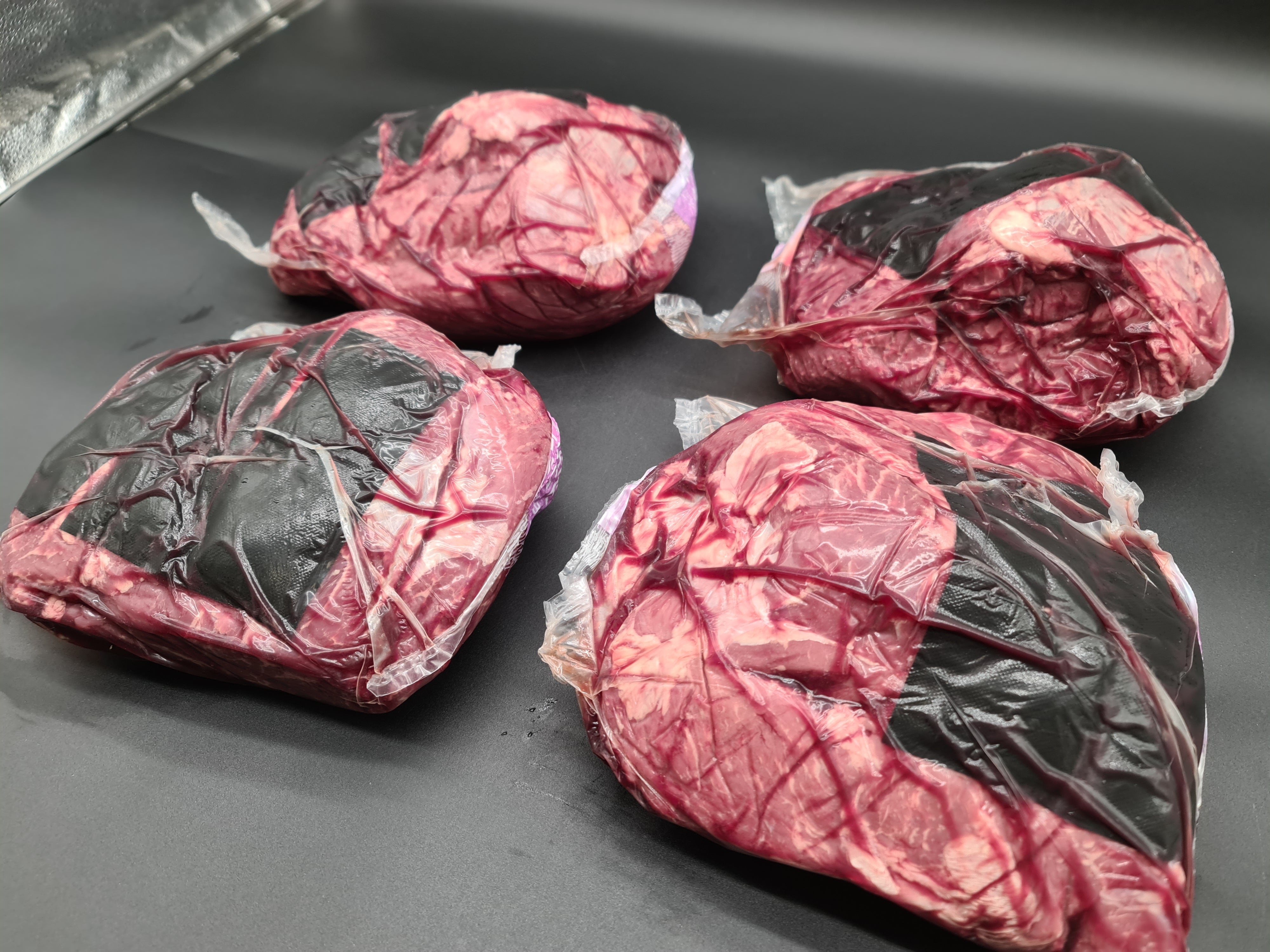 Top view of premium meat cuts packed inside an open box