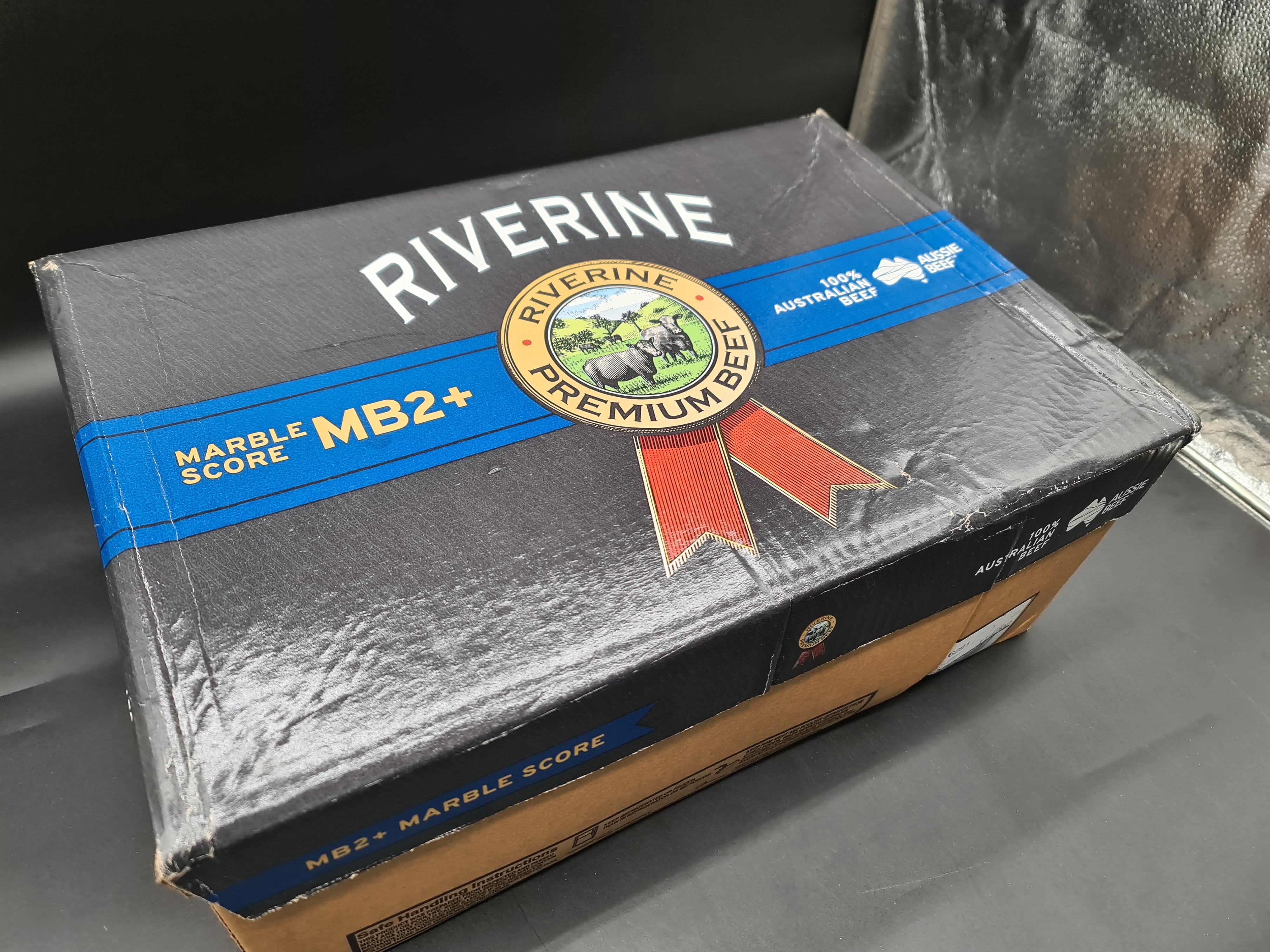 Angled view of packed premium meat cuts in a box