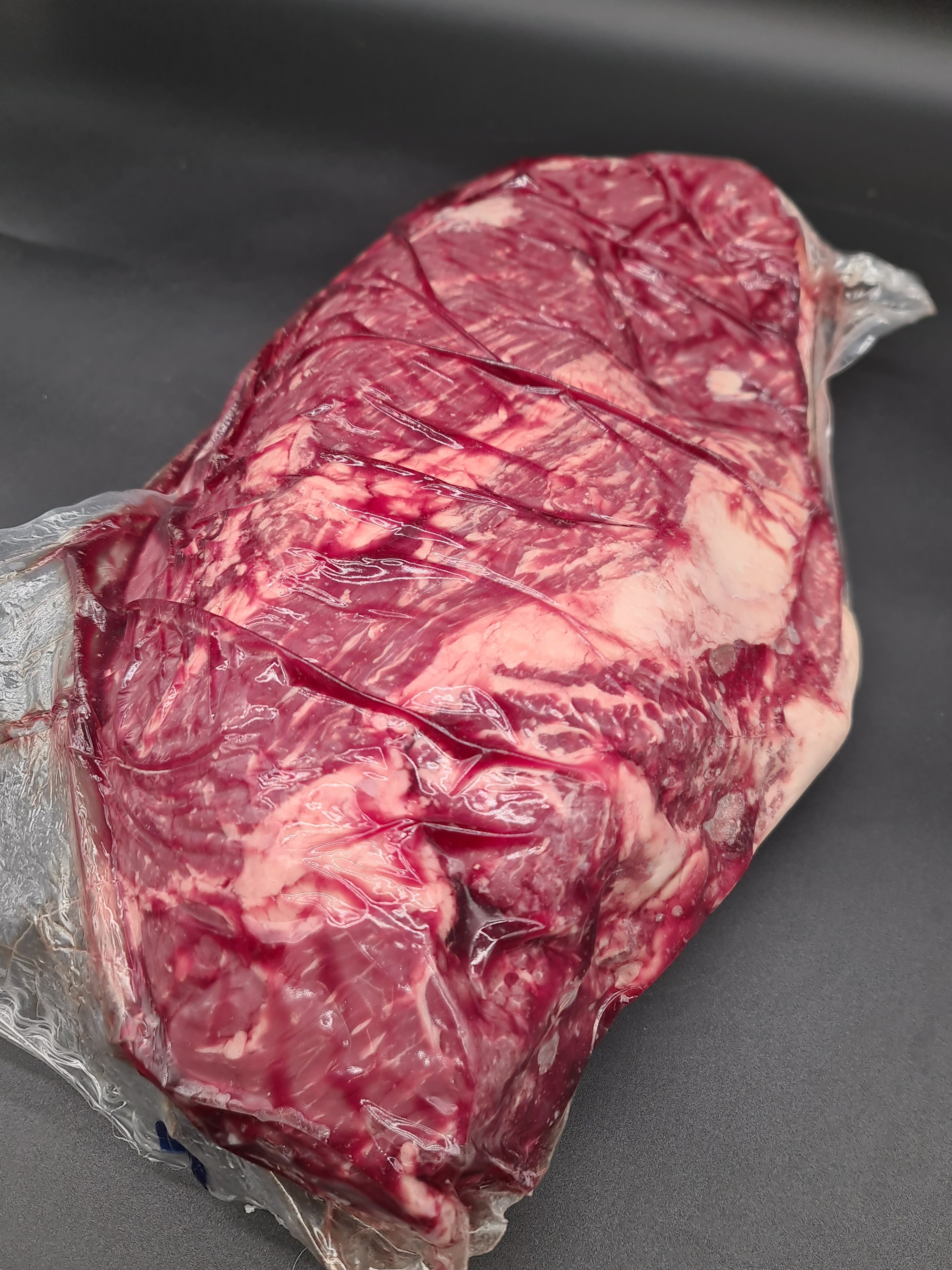 Open box filled with vacuum-packed premium meat cuts