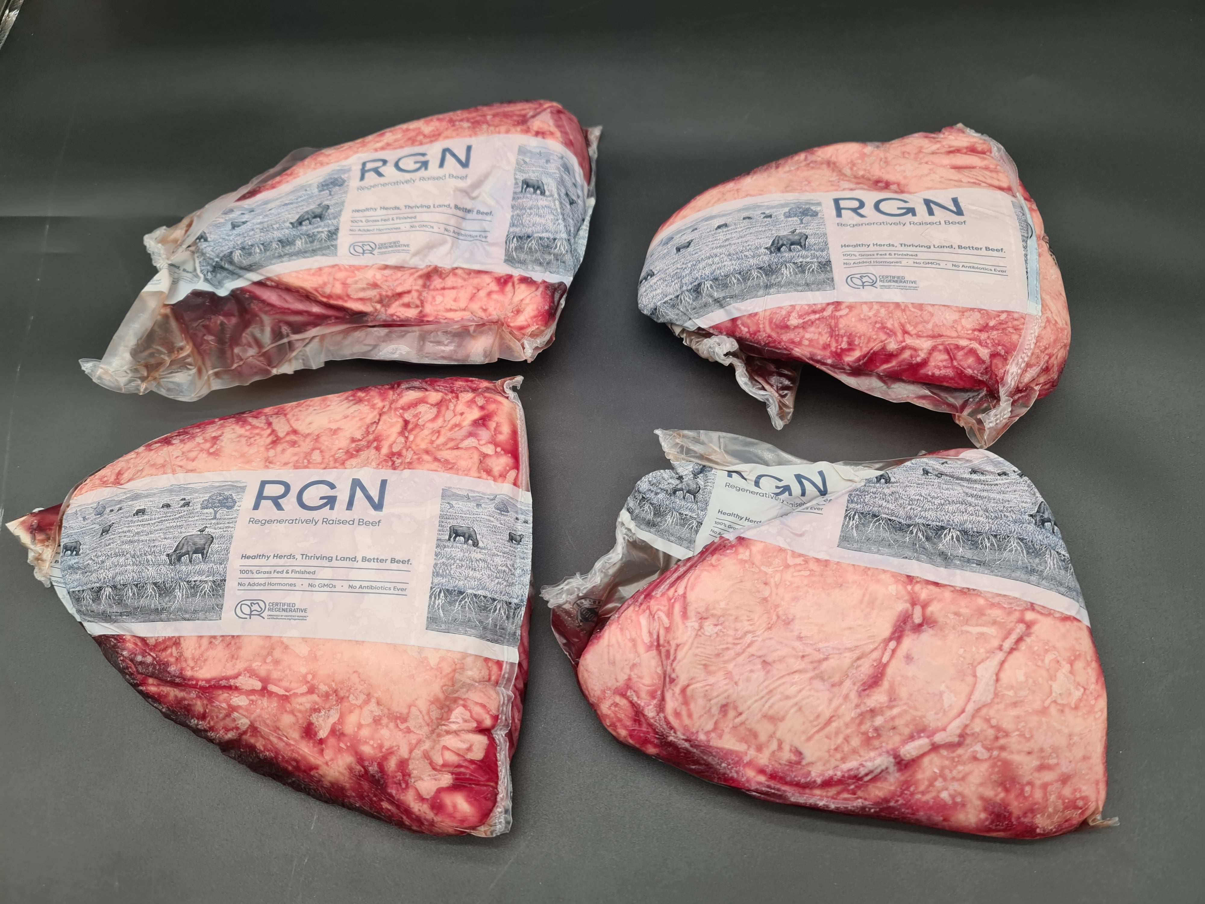 Open box filled with vacuum-packed premium meat cuts