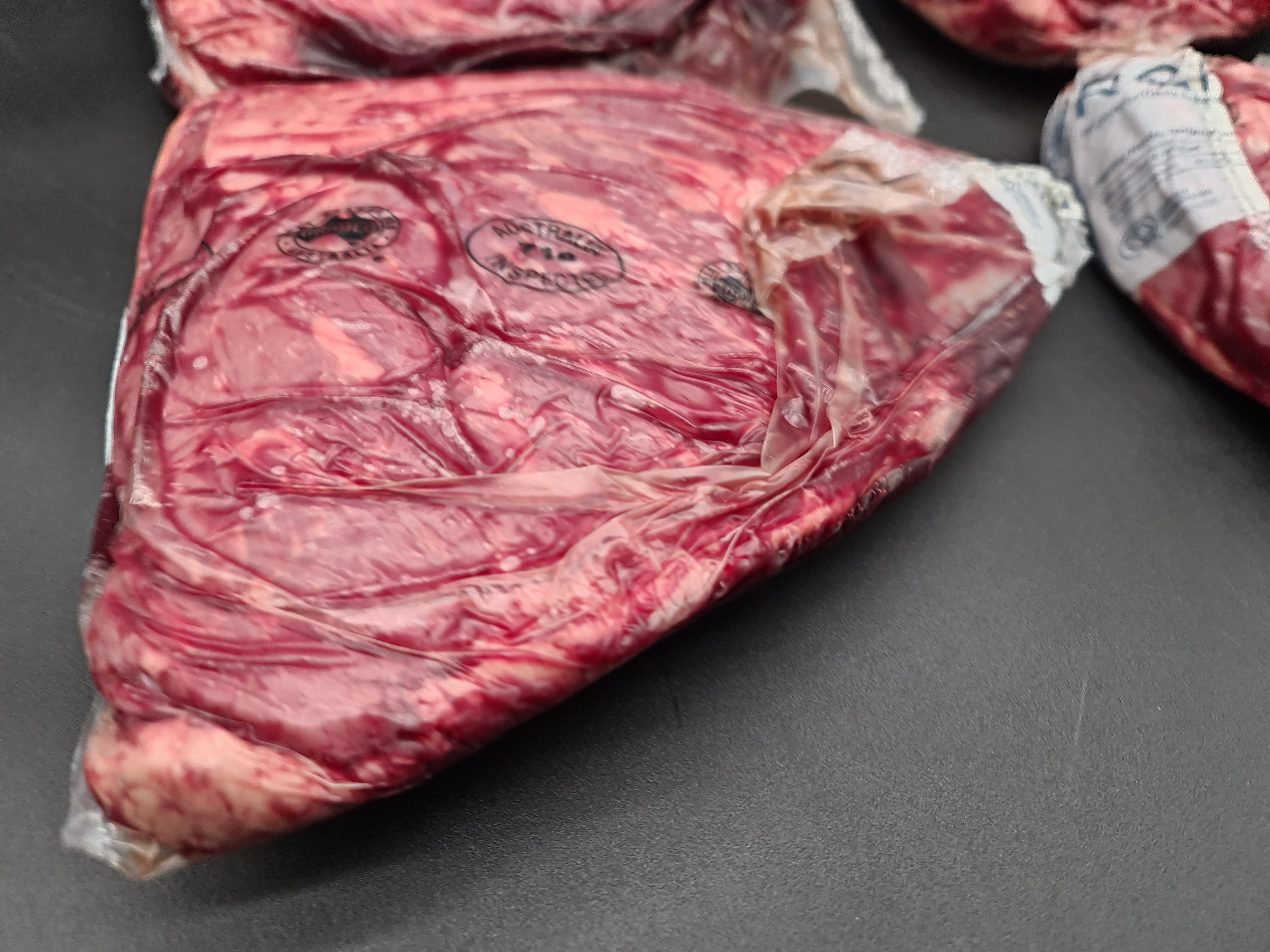 Closed premium meat box on a dark studio surface