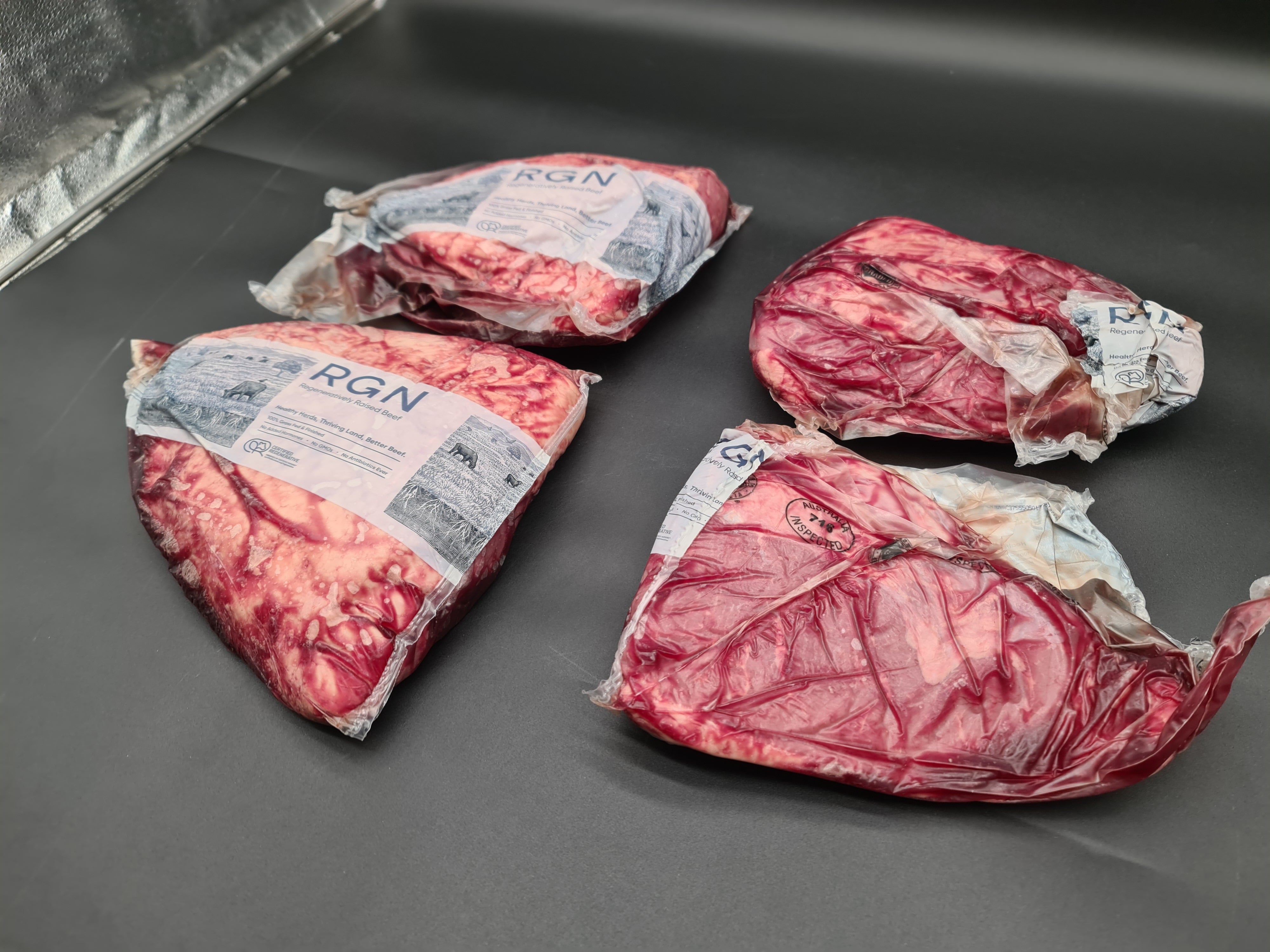 Two premium meat cuts side by side in vacuum packaging