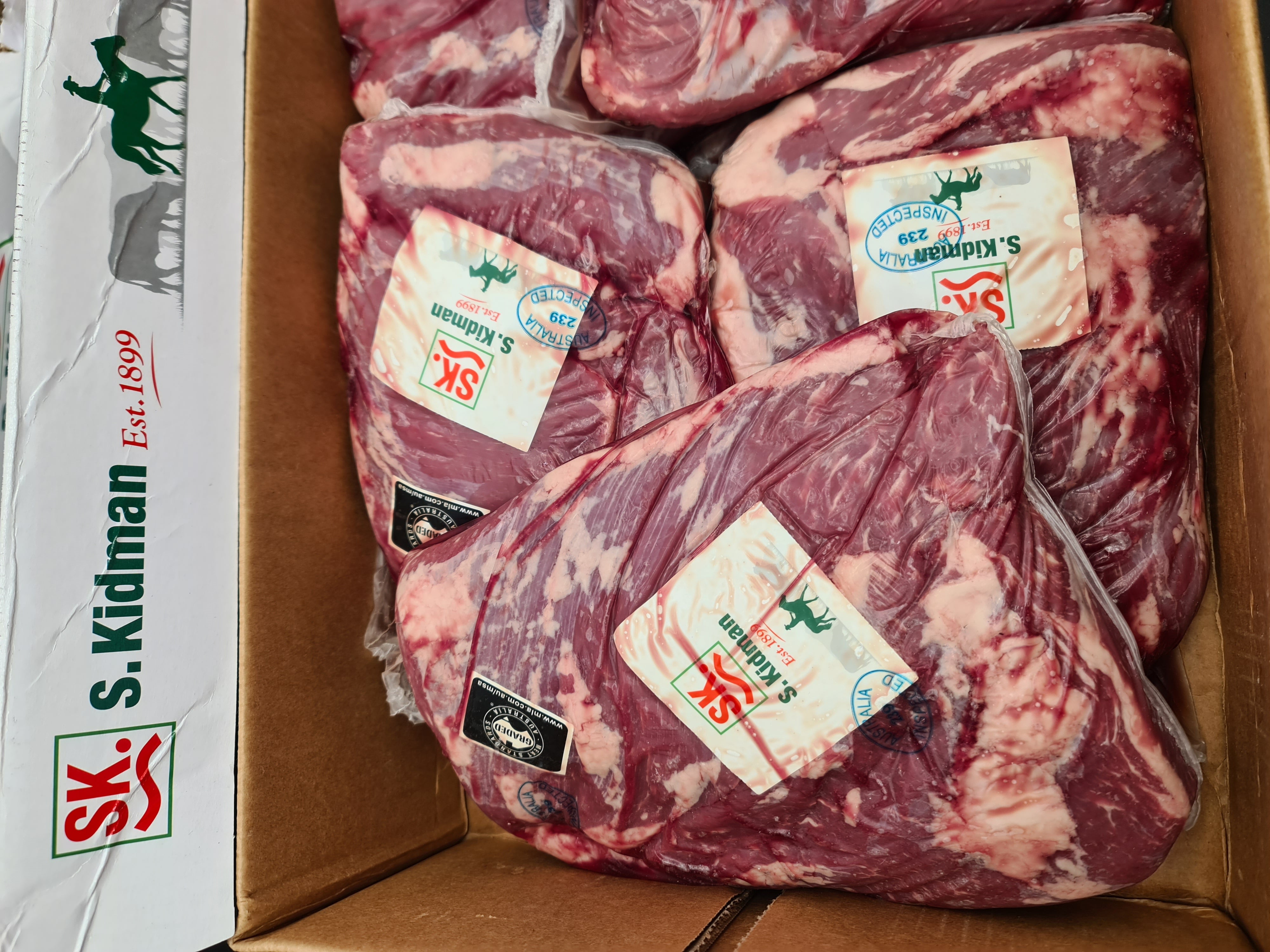 Two premium meat cuts side by side in vacuum packaging