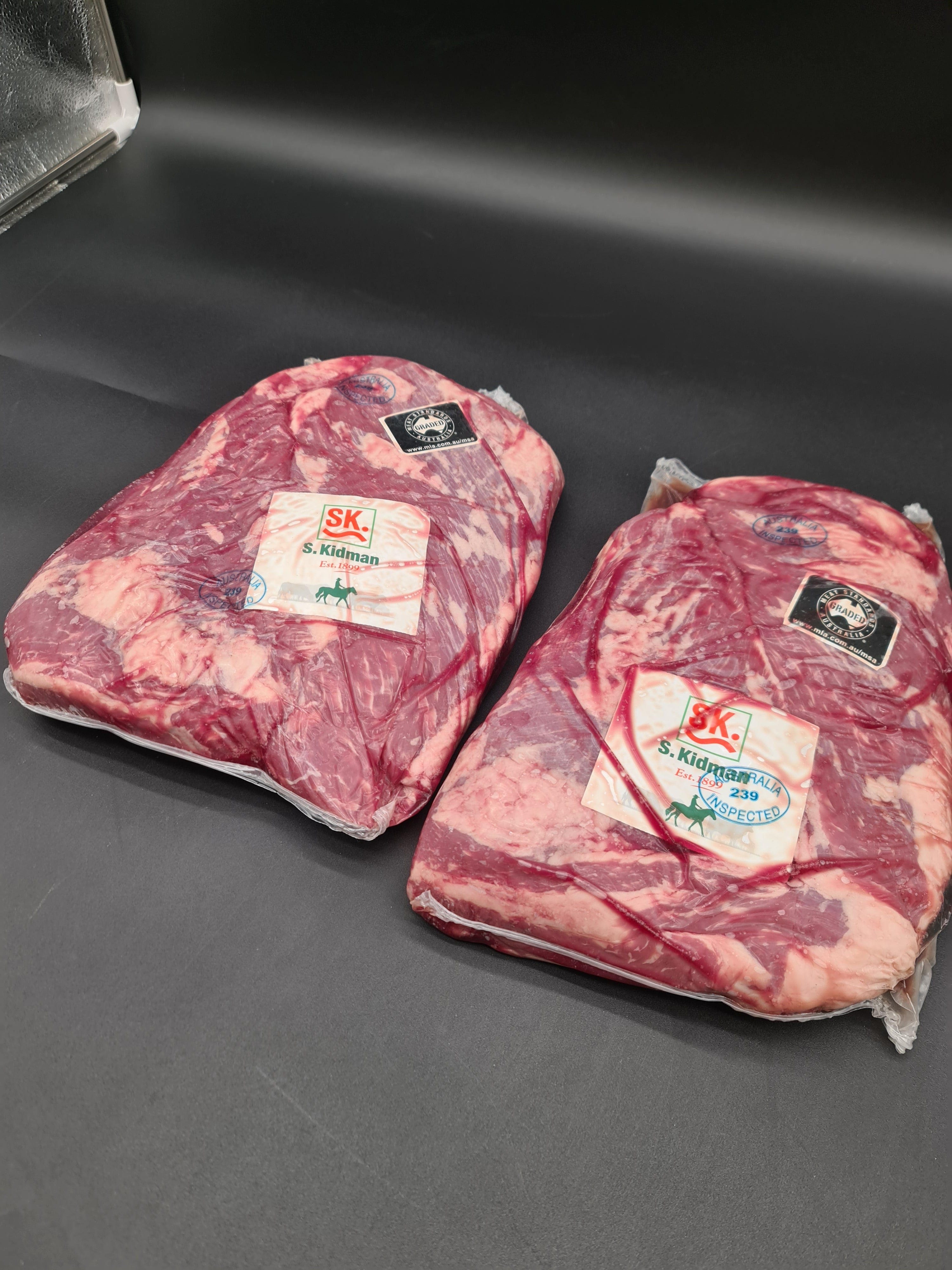 Open box filled with vacuum-packed premium meat cuts