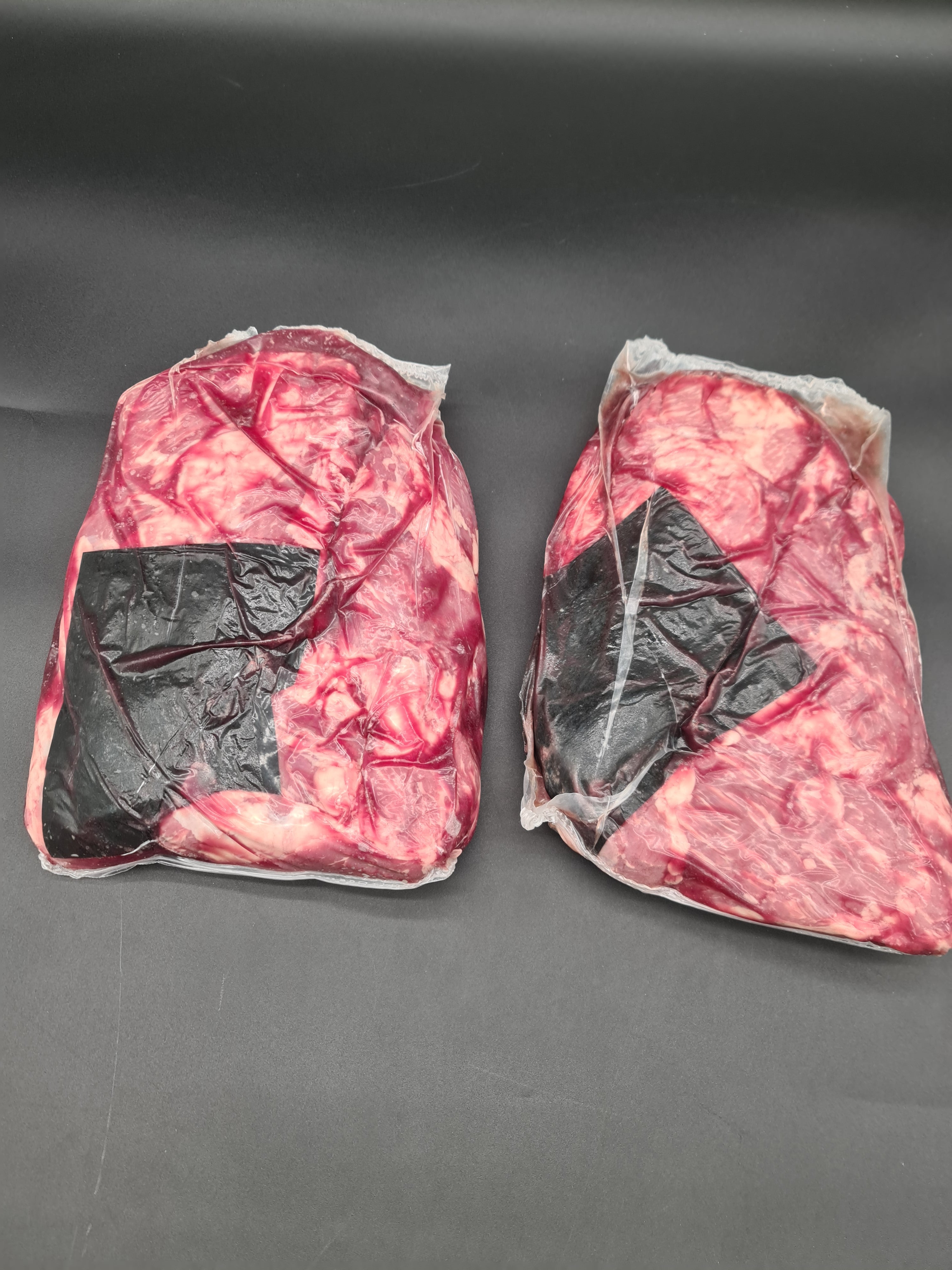 Top view of premium meat cuts packed inside an open box